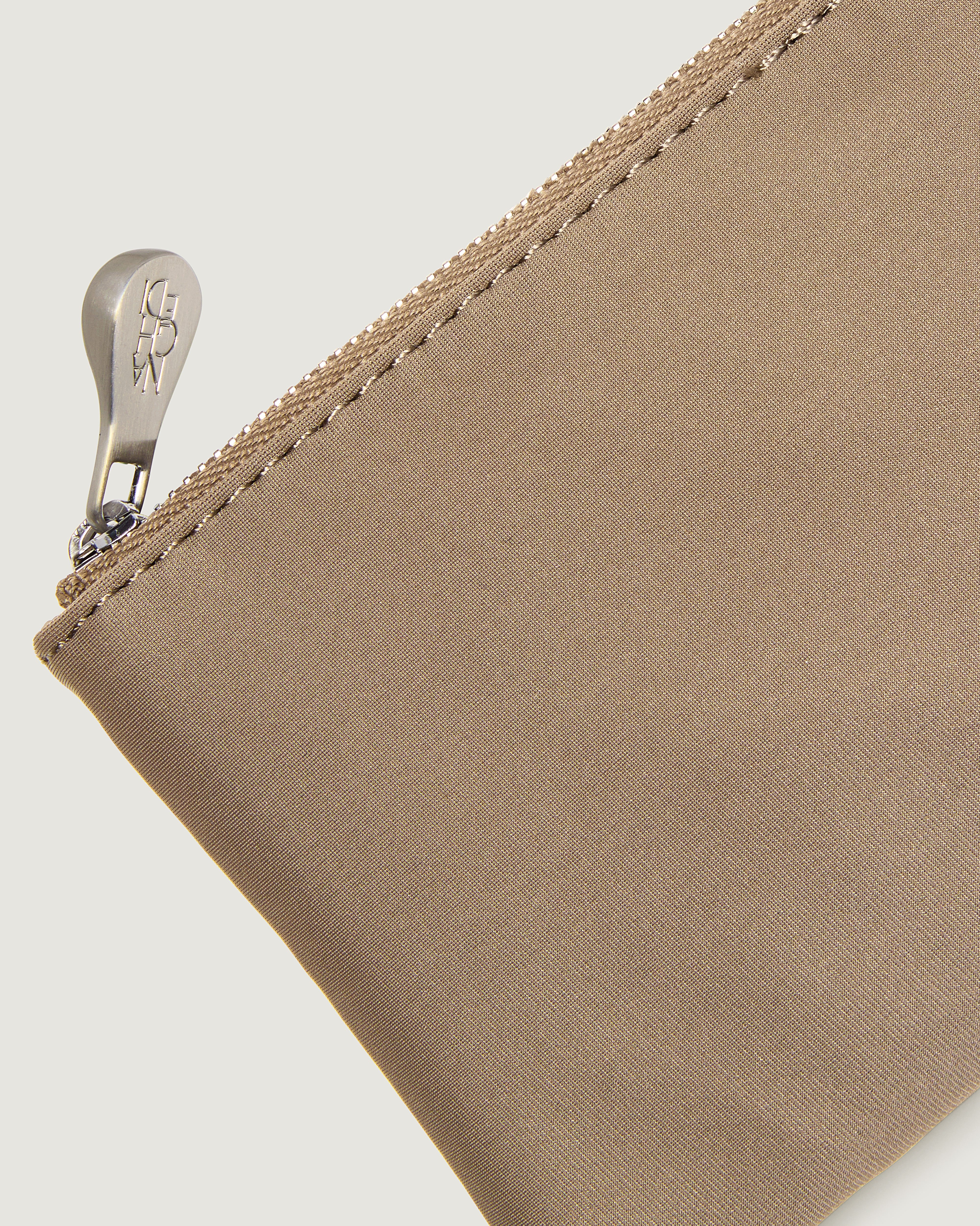 Close-up of a cool taupe nylon pouch with a silver zipper pull