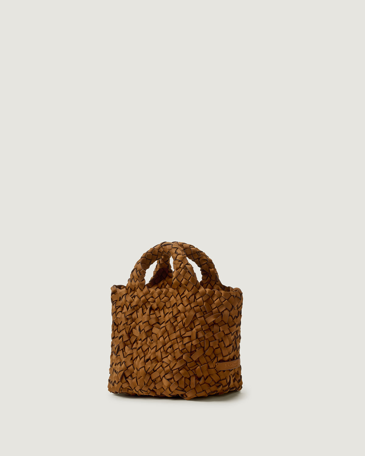 Side view of St. Barths Petit Nest Weave tote in Teak, highlighting open top and cross-hatch weave