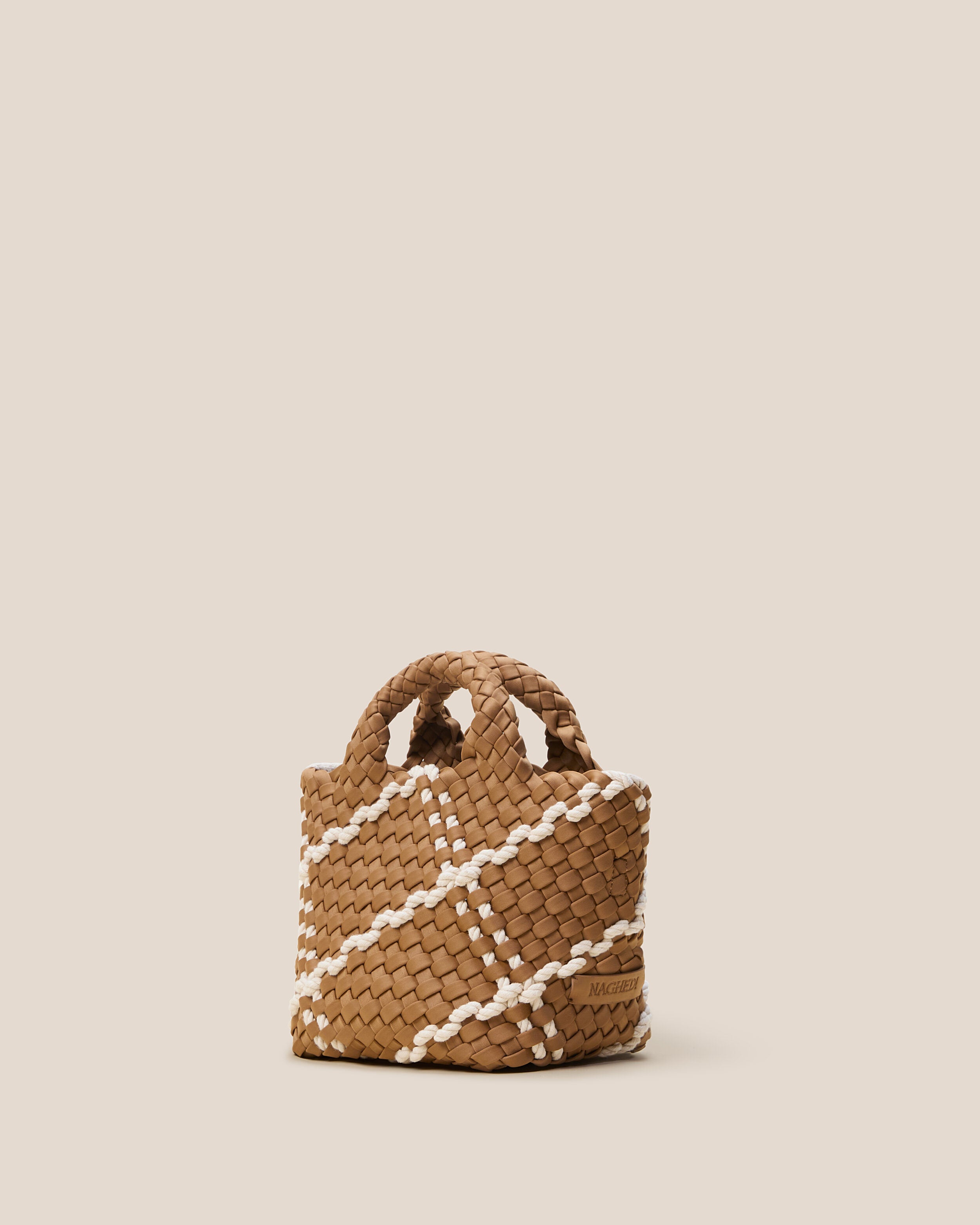 St. Barths Tote in Cove shown from a side angle, highlighting its handwoven neoprene construction and open top.