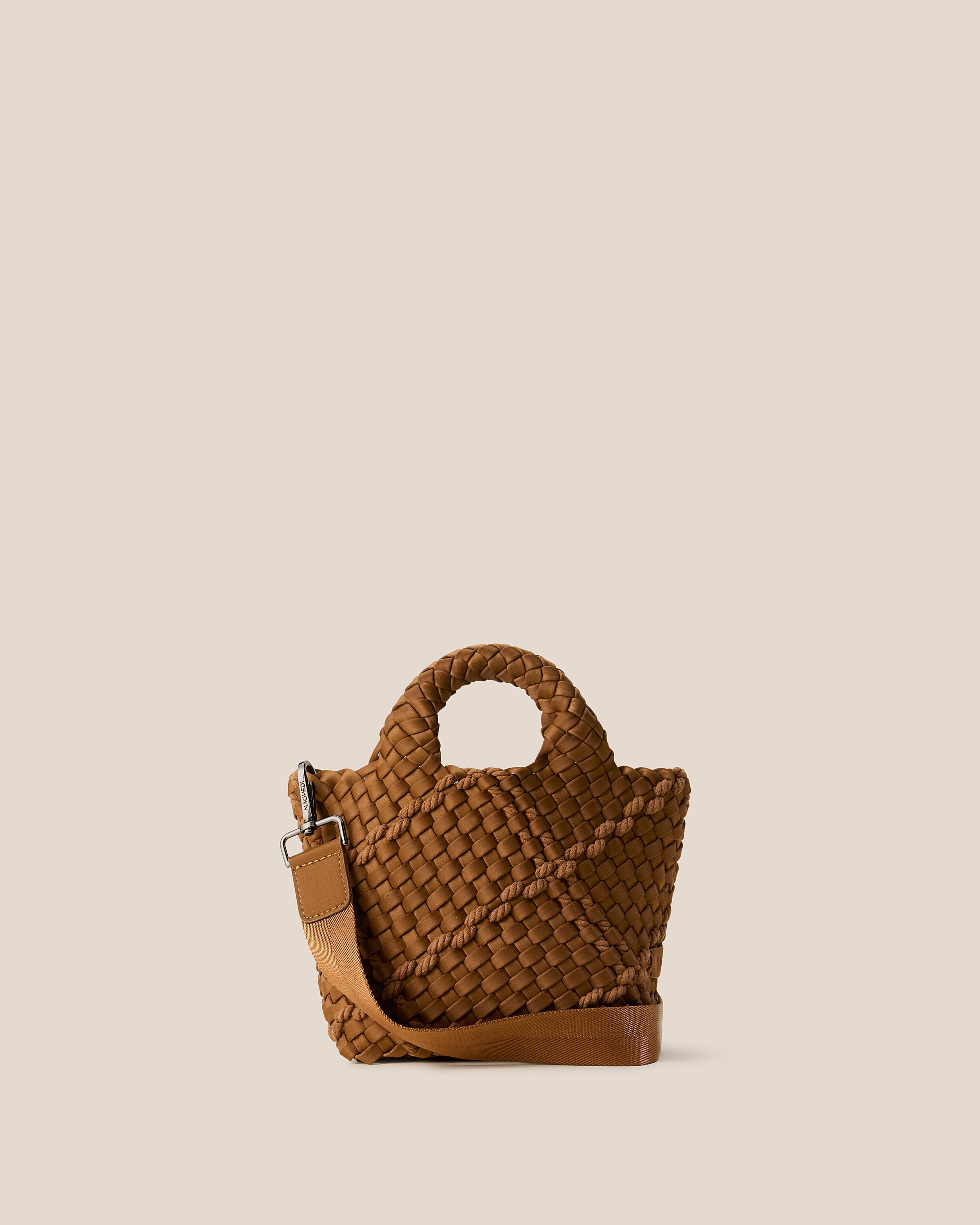 St. Barths Tote in Harbor, a saddle brown tone, in handwoven neoprene, featuring an open top, woven top handles, and detachable, adjustable nylon crossbody strap.