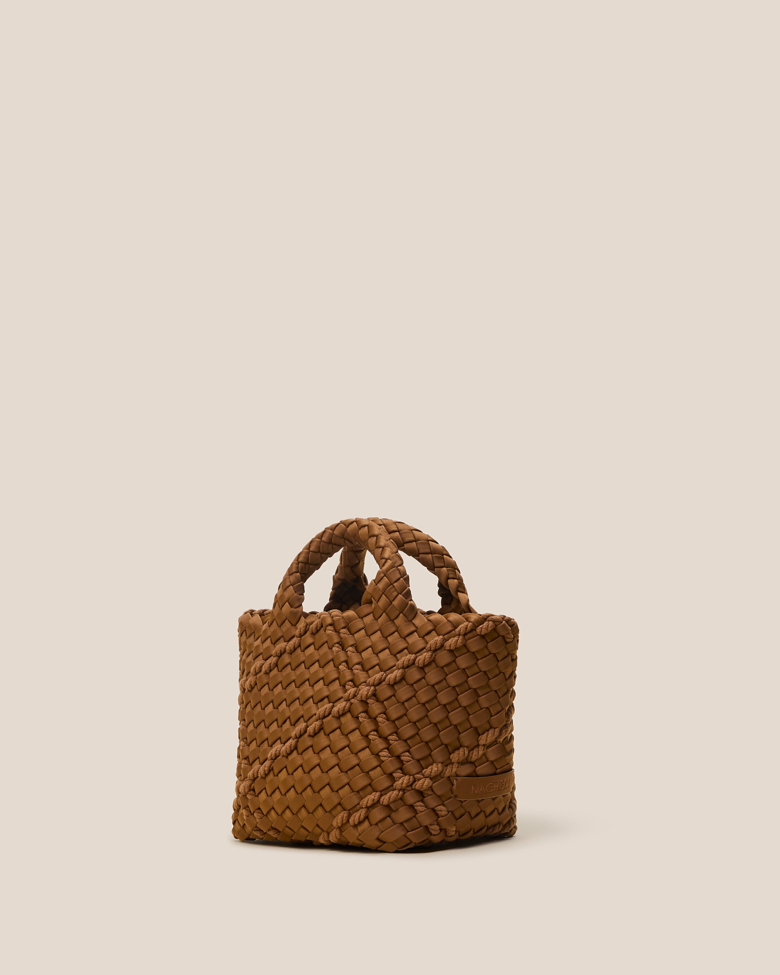 St. Barths Tote in Harbor shown from a side angle, highlighting its handwoven neoprene construction and open top.