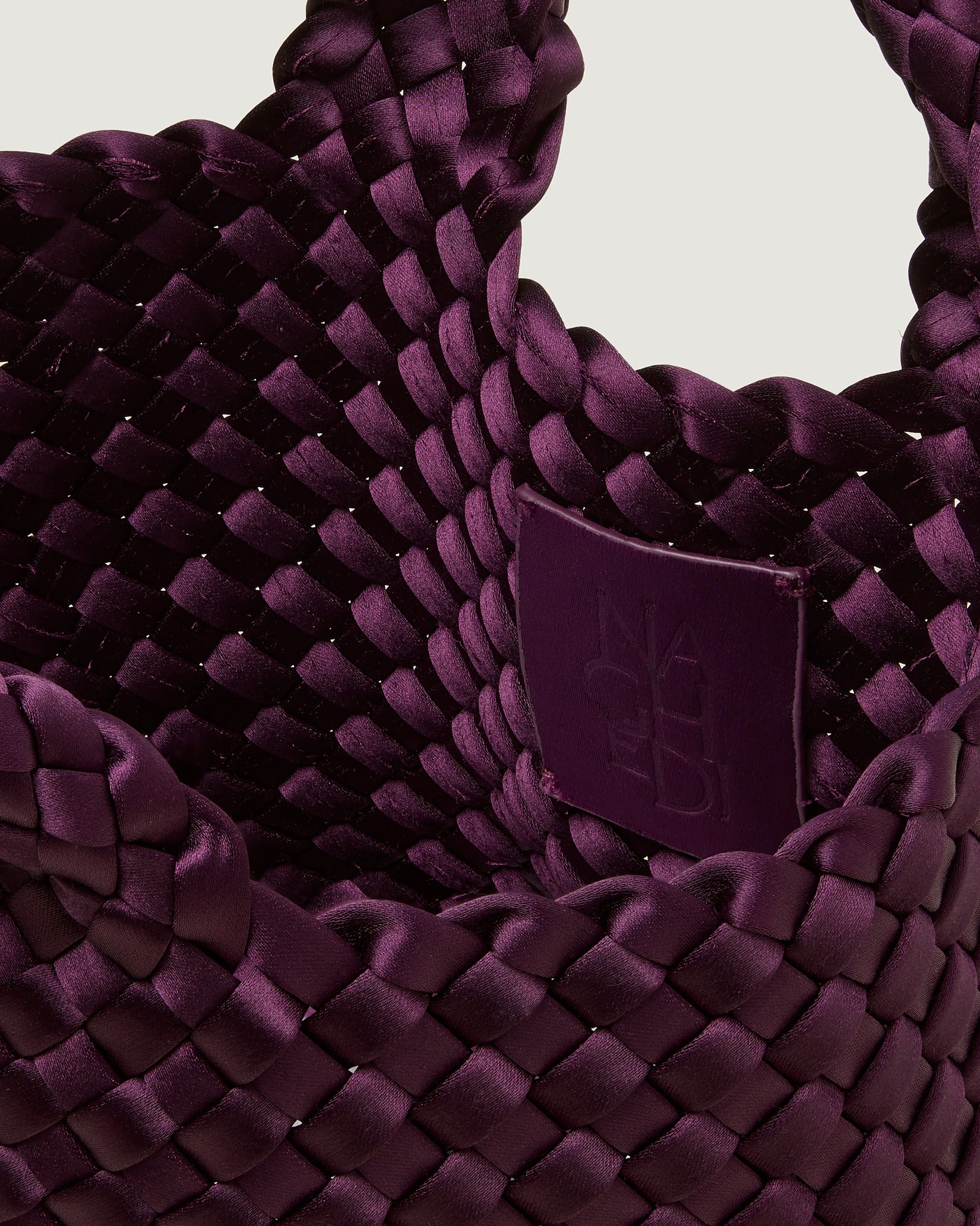 Interior close-up of St. Barths Petit Satin Tote Bag in Currant showing its open top, and unlined interior.
