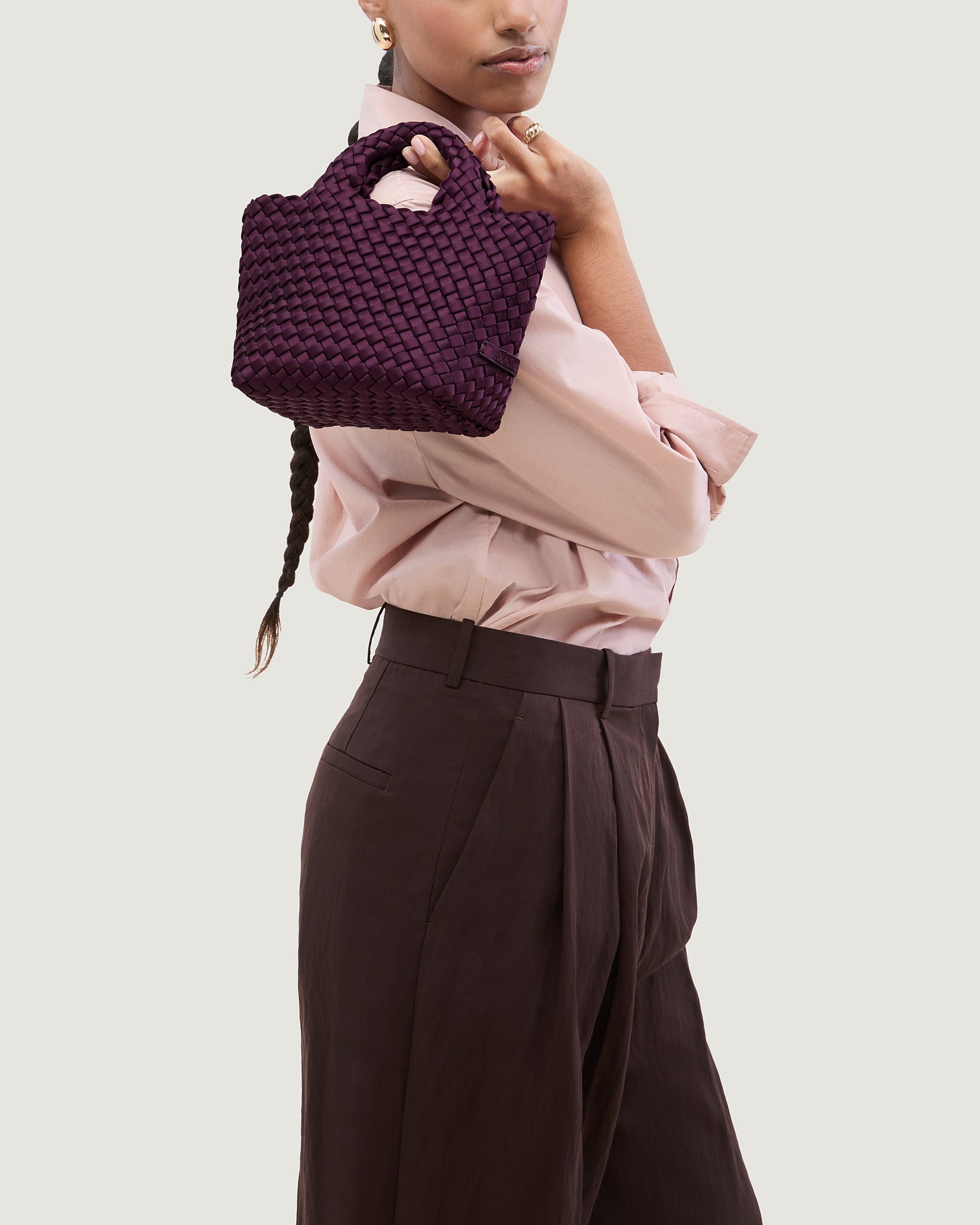 St. Barths Petit Satin Tote Bag in Currant shown on model to illustrate scale and soft silhouette.