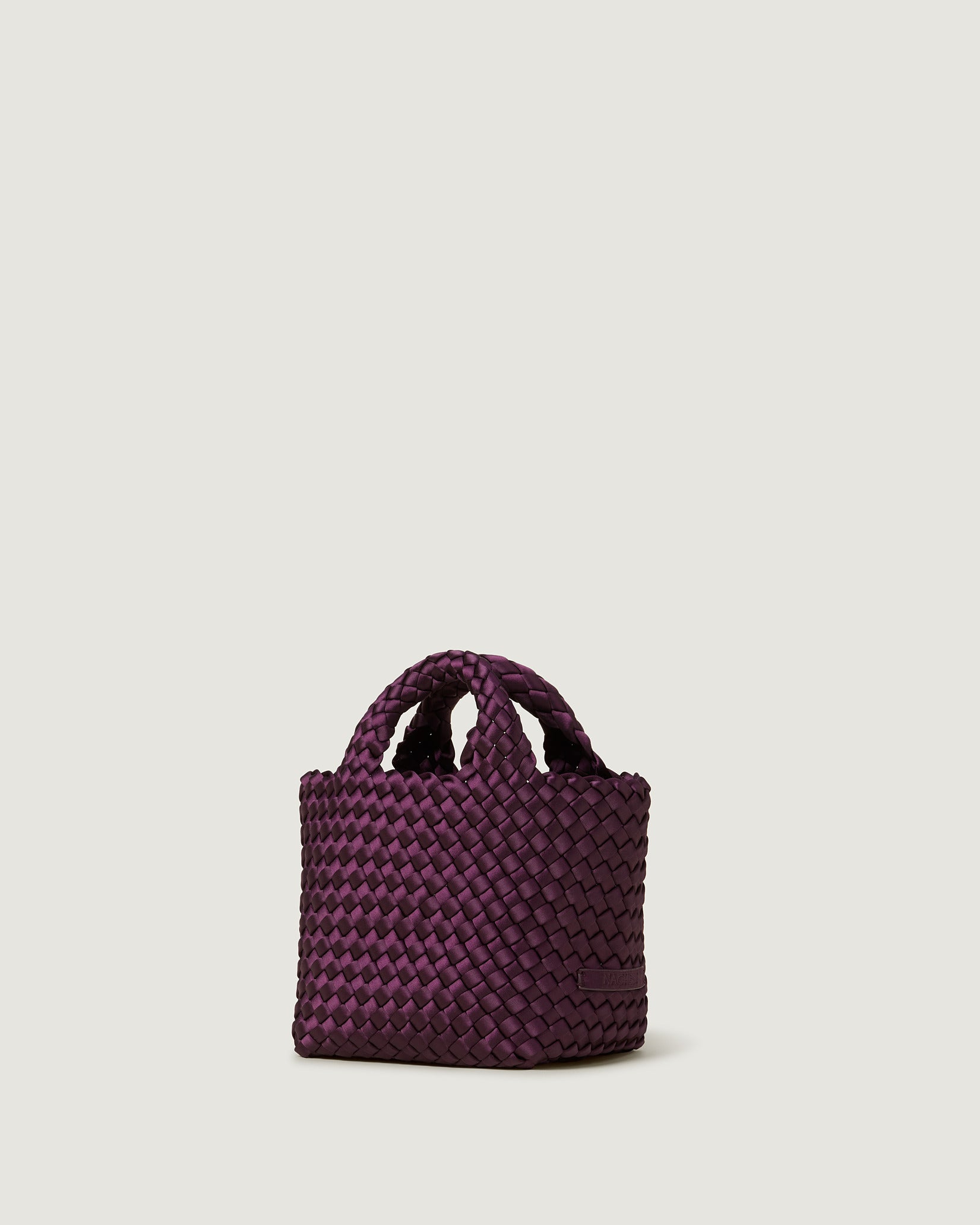St. Barths Petit Satin Tote Bag in Currant shown from a side angle, highlighting its handwoven neoprene and open top.