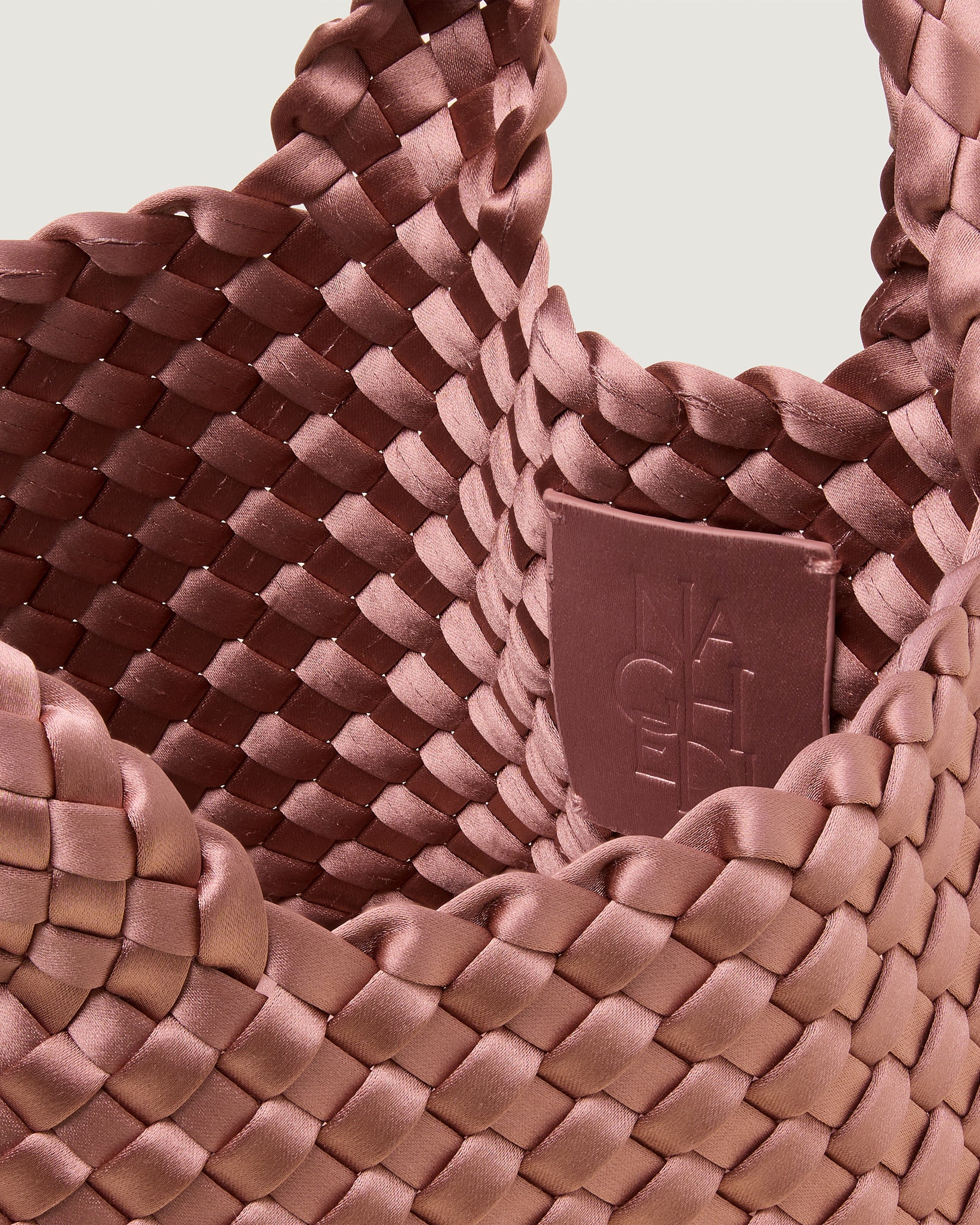 Interior close-up of St. Barths Petit Satin Tote Bag in Daphne showing its open top, and unlined interior.
