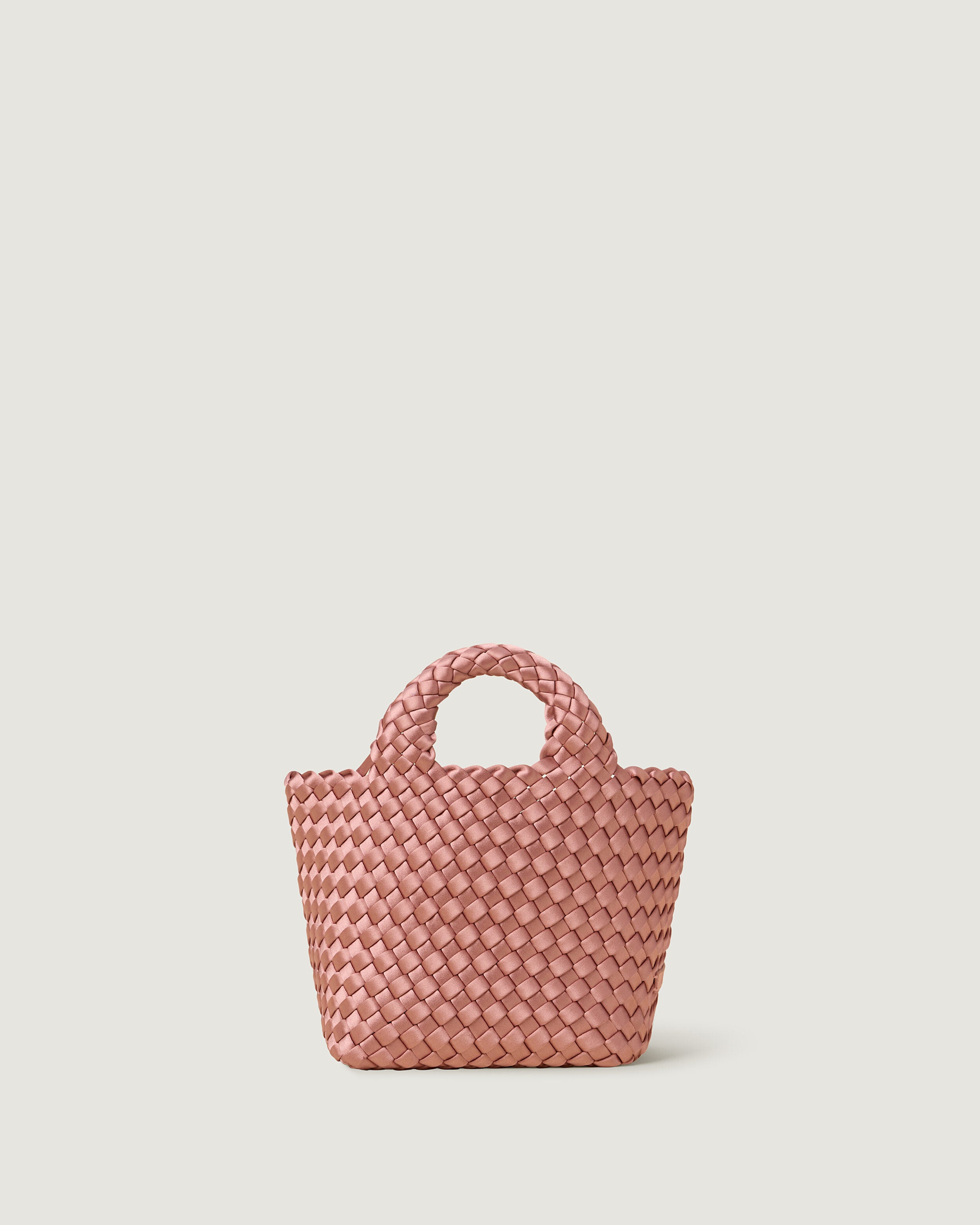St. Barths Tote in Daphne, a coral pink tone, in handwoven neoprene, featuring an open top, and woven top handles.