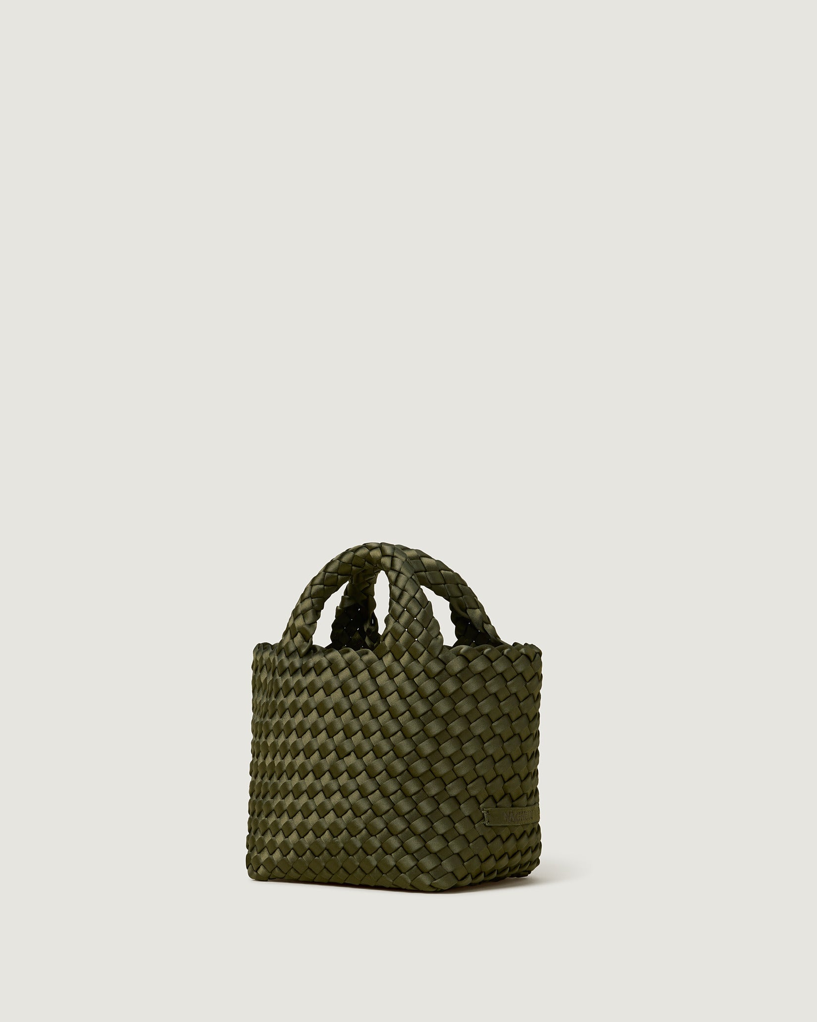 St. Barths Petit Satin Tote Bag in Juniper shown from a side angle, highlighting its handwoven neoprene and open top.