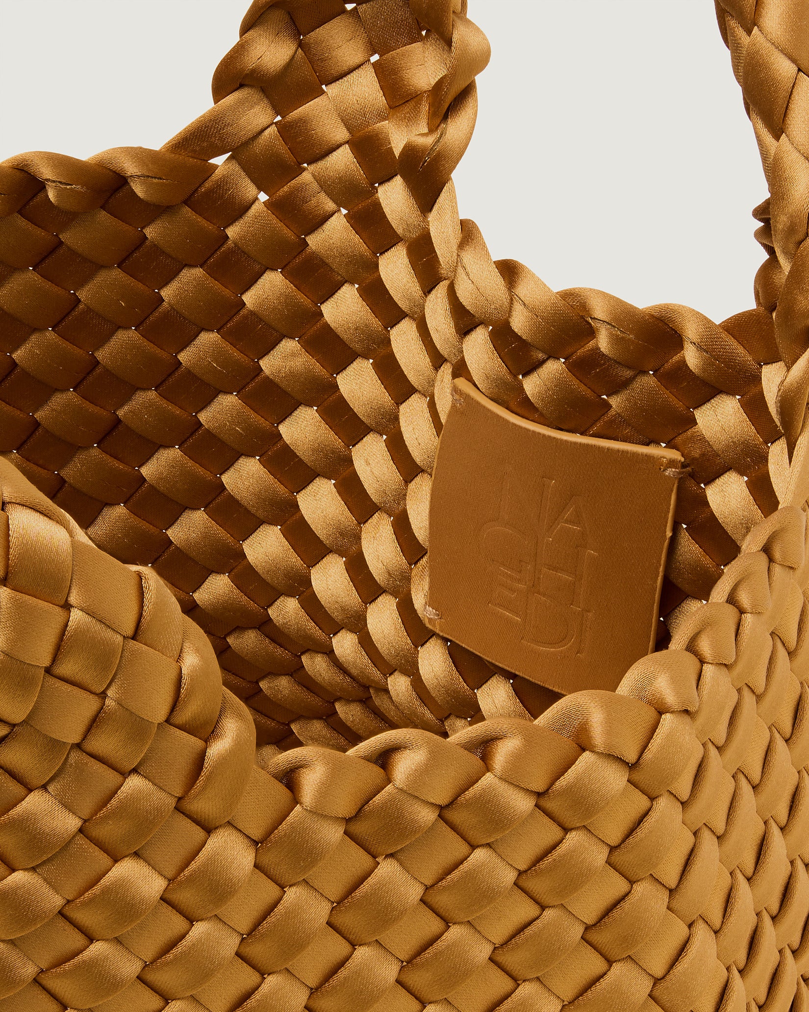 Interior close-up of St. Barths Petit Satin Tote Bag in Ore showing its open top, and unlined interior.