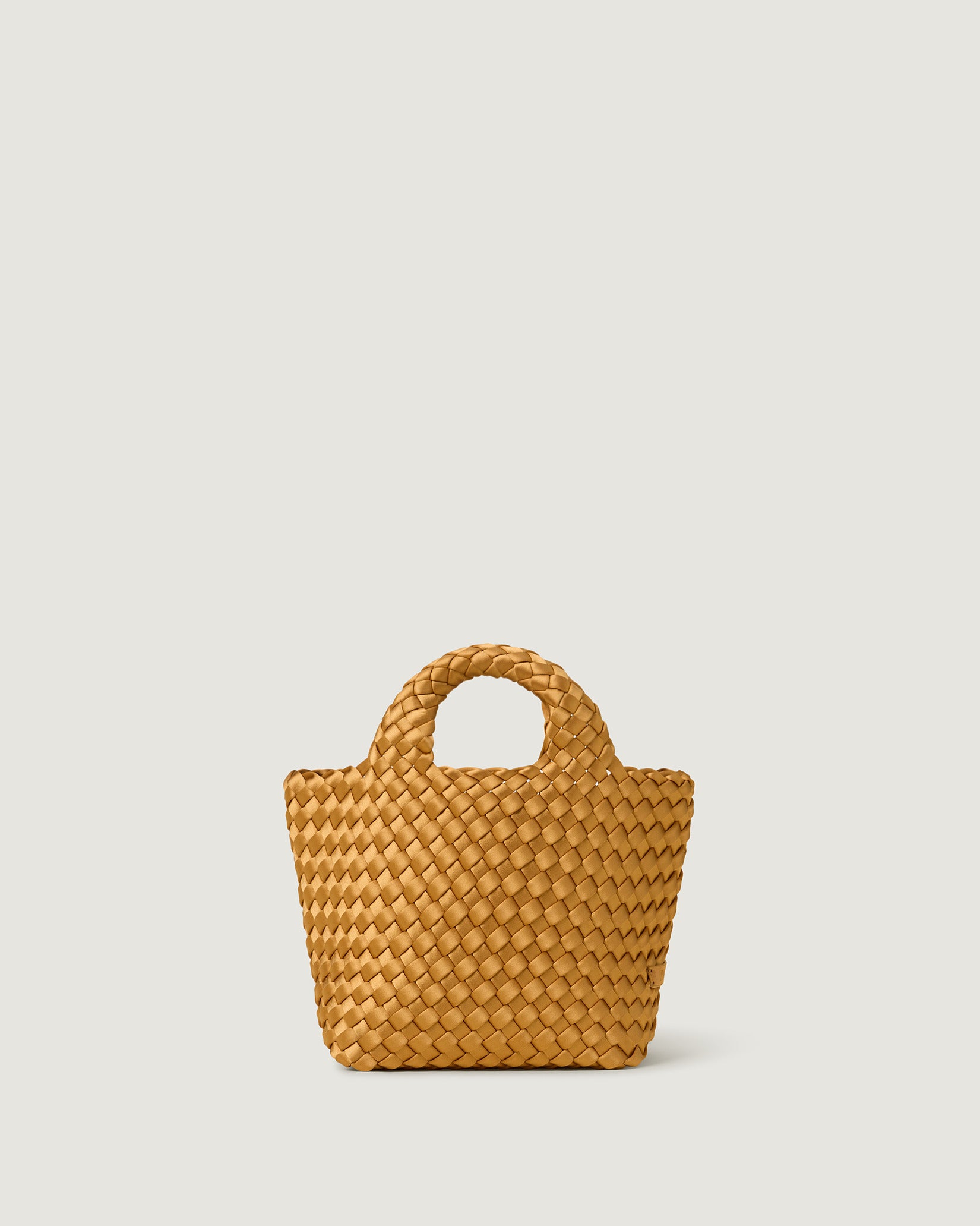 St. Barths Petit Satin Tote Bag in Ore, a golden yellow tone, in handwoven neoprene featuring an open top, woven top handles, and detachable, adjustable nylon crossbody strap.