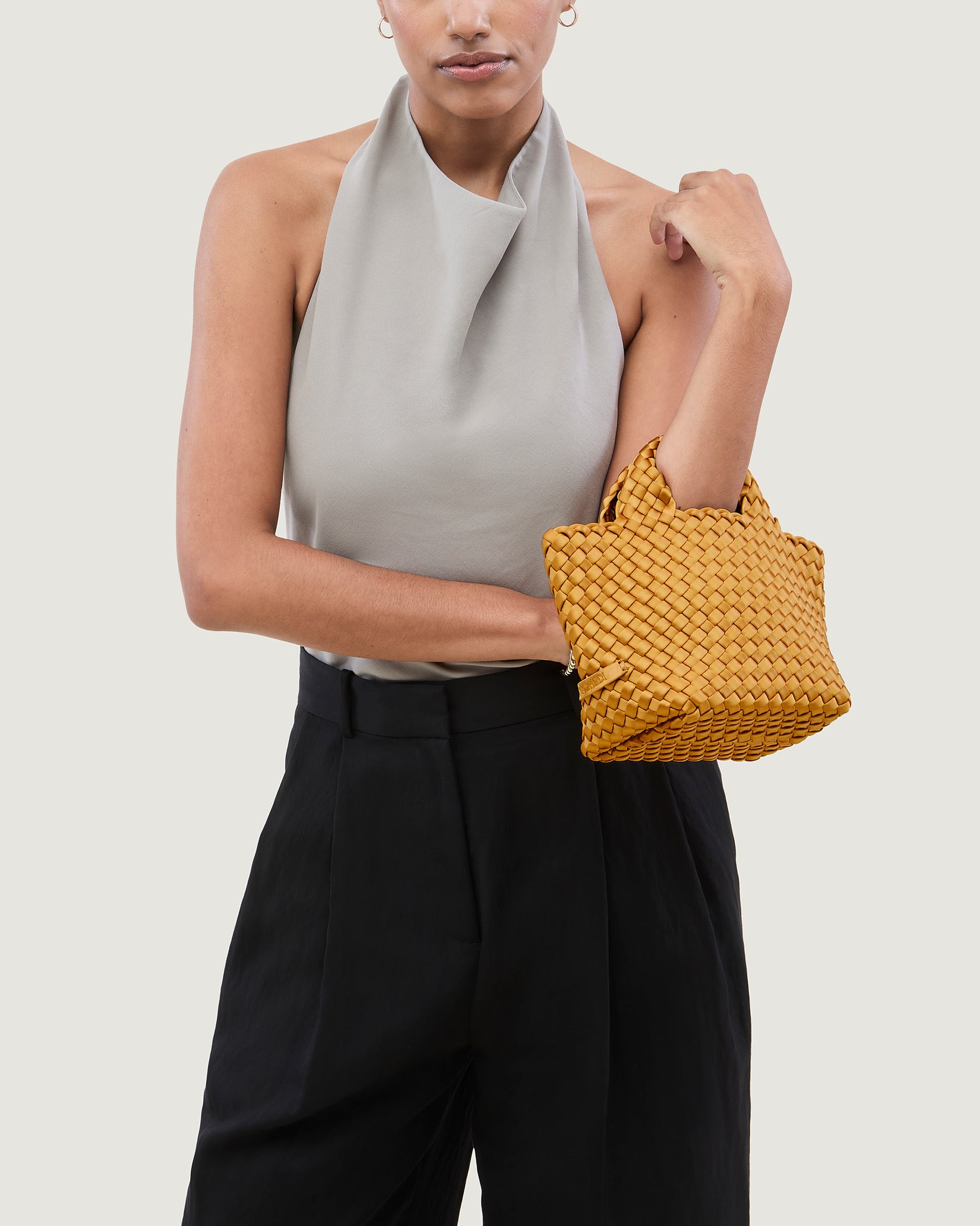 St. Barths Petit Satin Tote Bag in Ore shown on model to illustrate scale and soft silhouette.