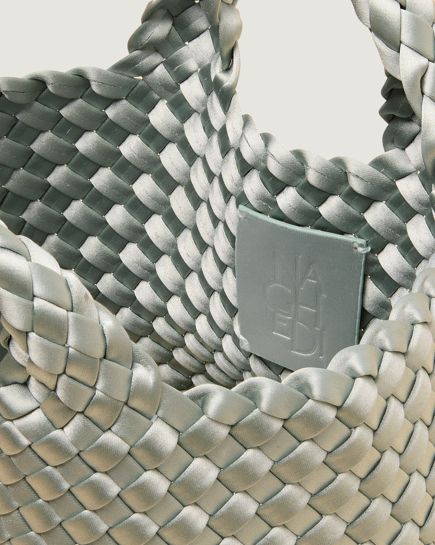 Interior close-up of St. Barths Petit Satin Tote Bag in Wintergreen showing its open top, and unlined interior.