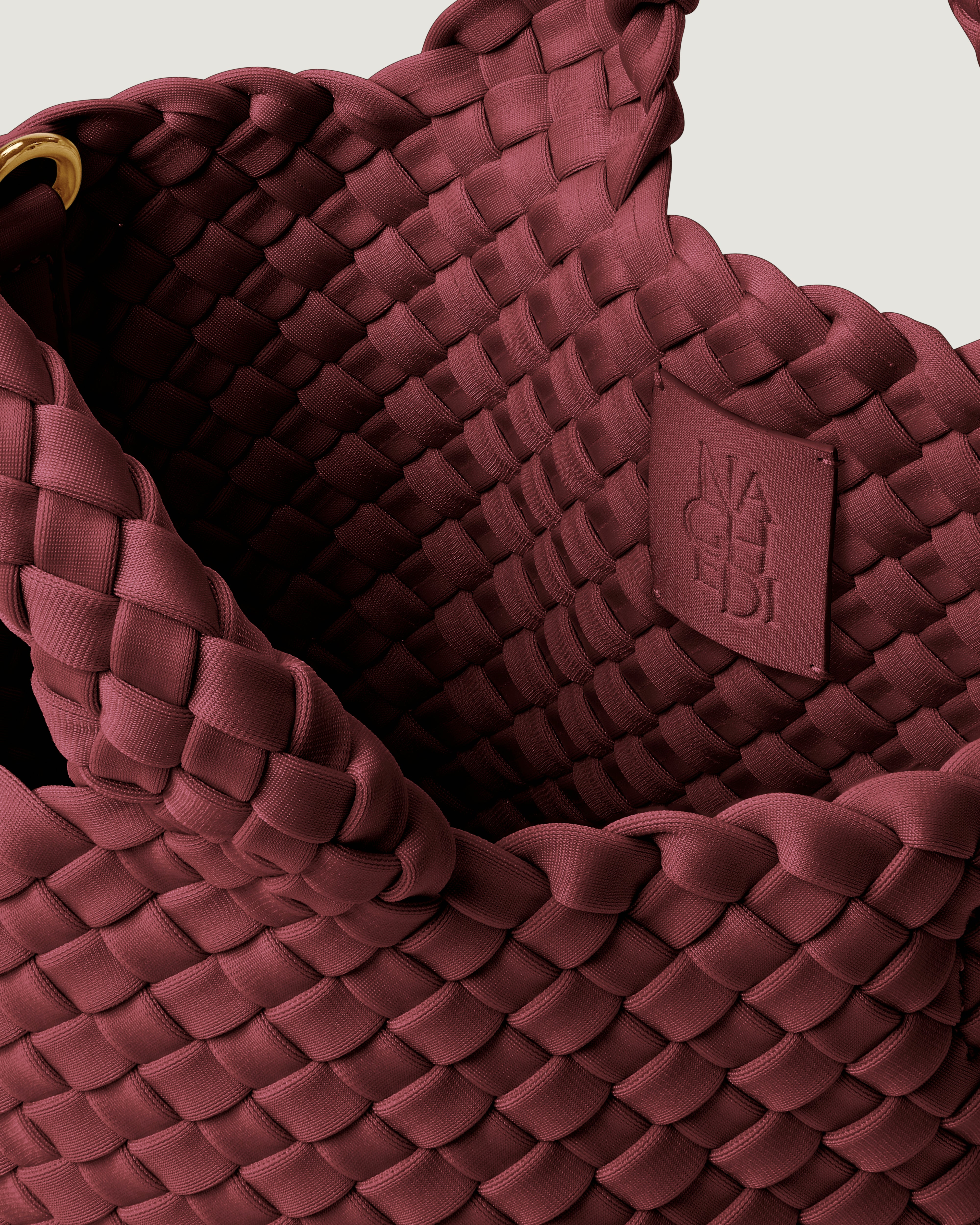 Interior close-up of St. Barths Tote in Bordeaux showing its open top, and unlined interior.