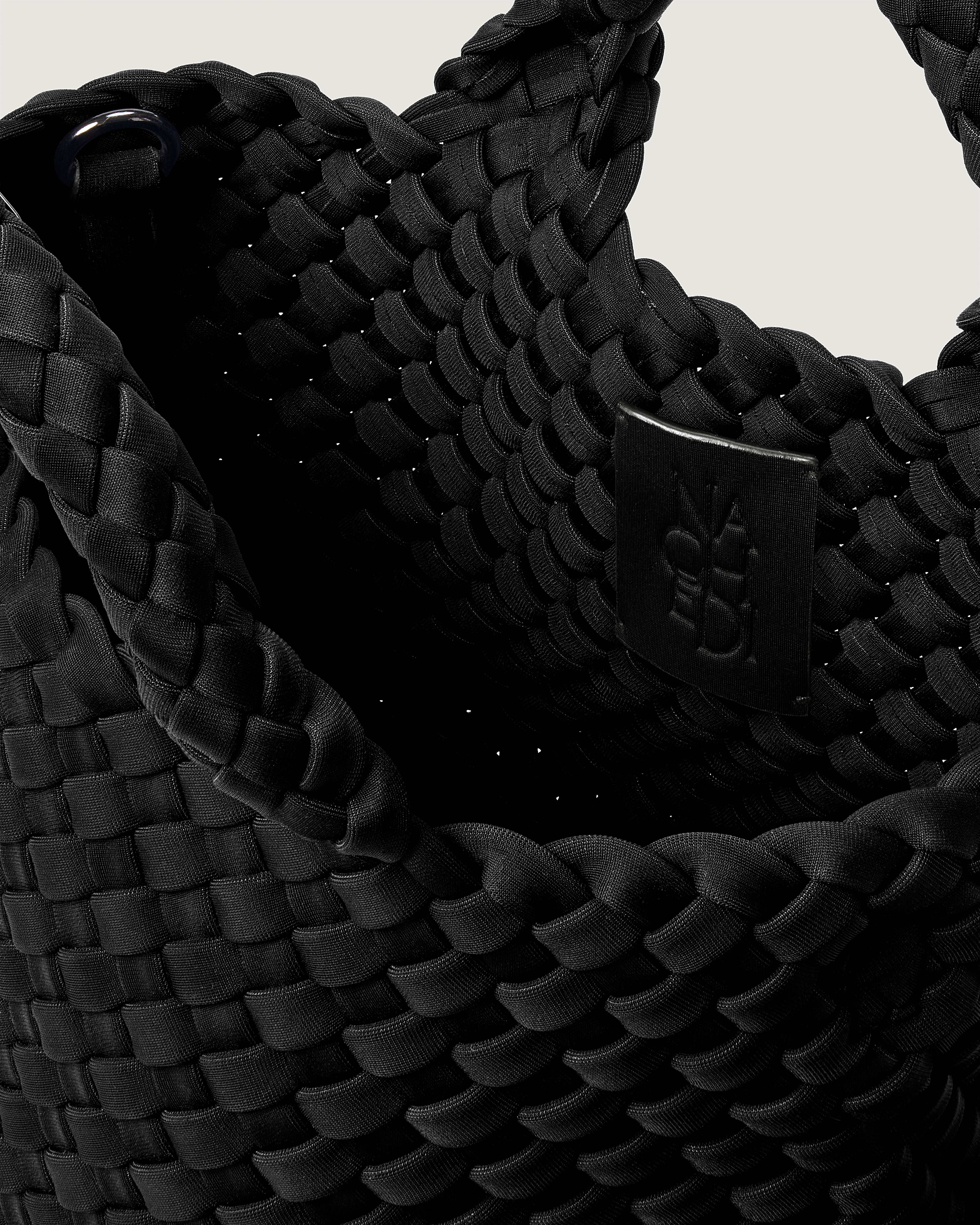 Interior close-up of St. Barths Tote in Onyx showing its open top, and unlined interior.