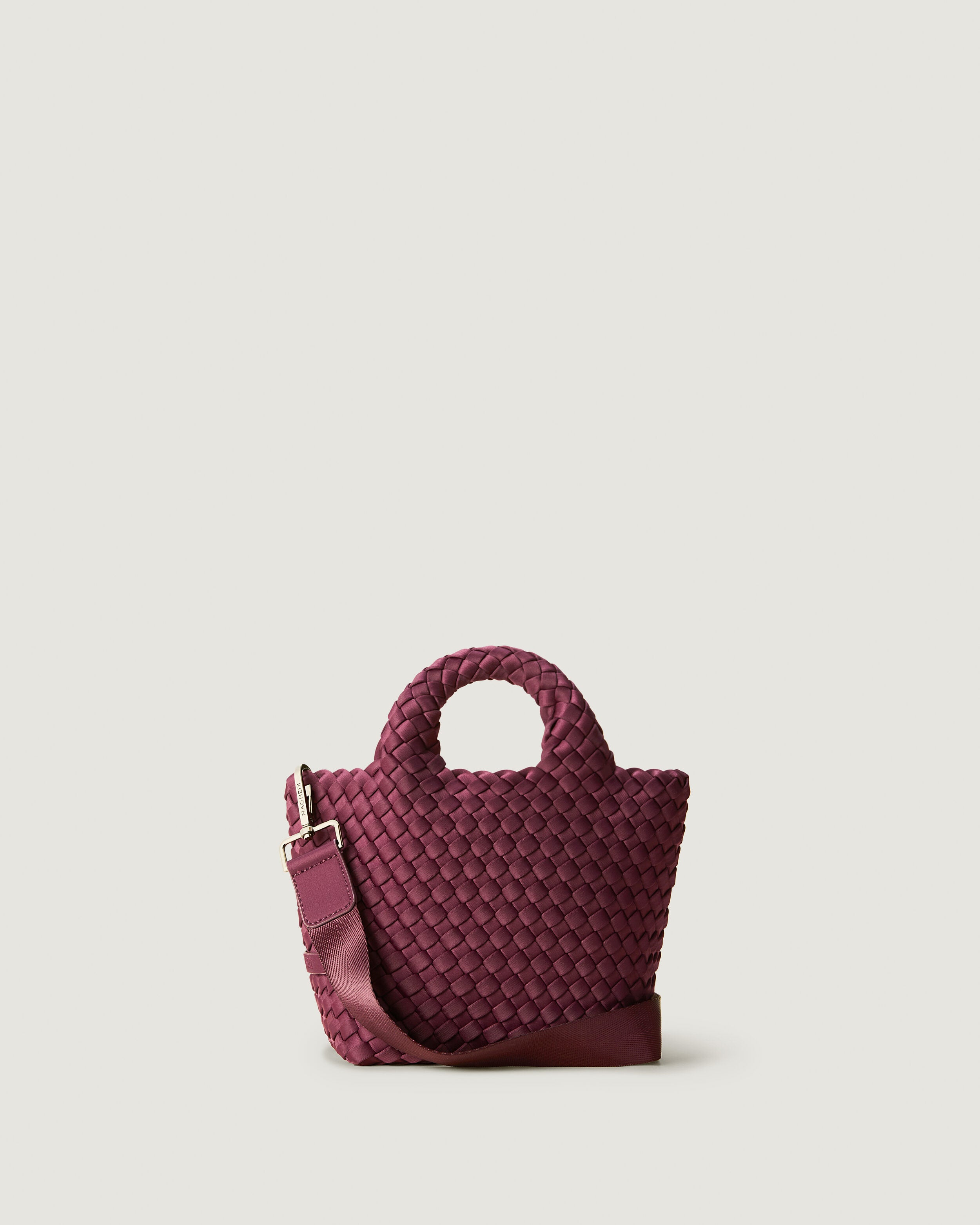 St. Barths Tote in Bordeaux, a rich burgundy tone, in handwoven neoprene, featuring an open top, woven top handles, and detachable, adjustable nylon crossbody strap.