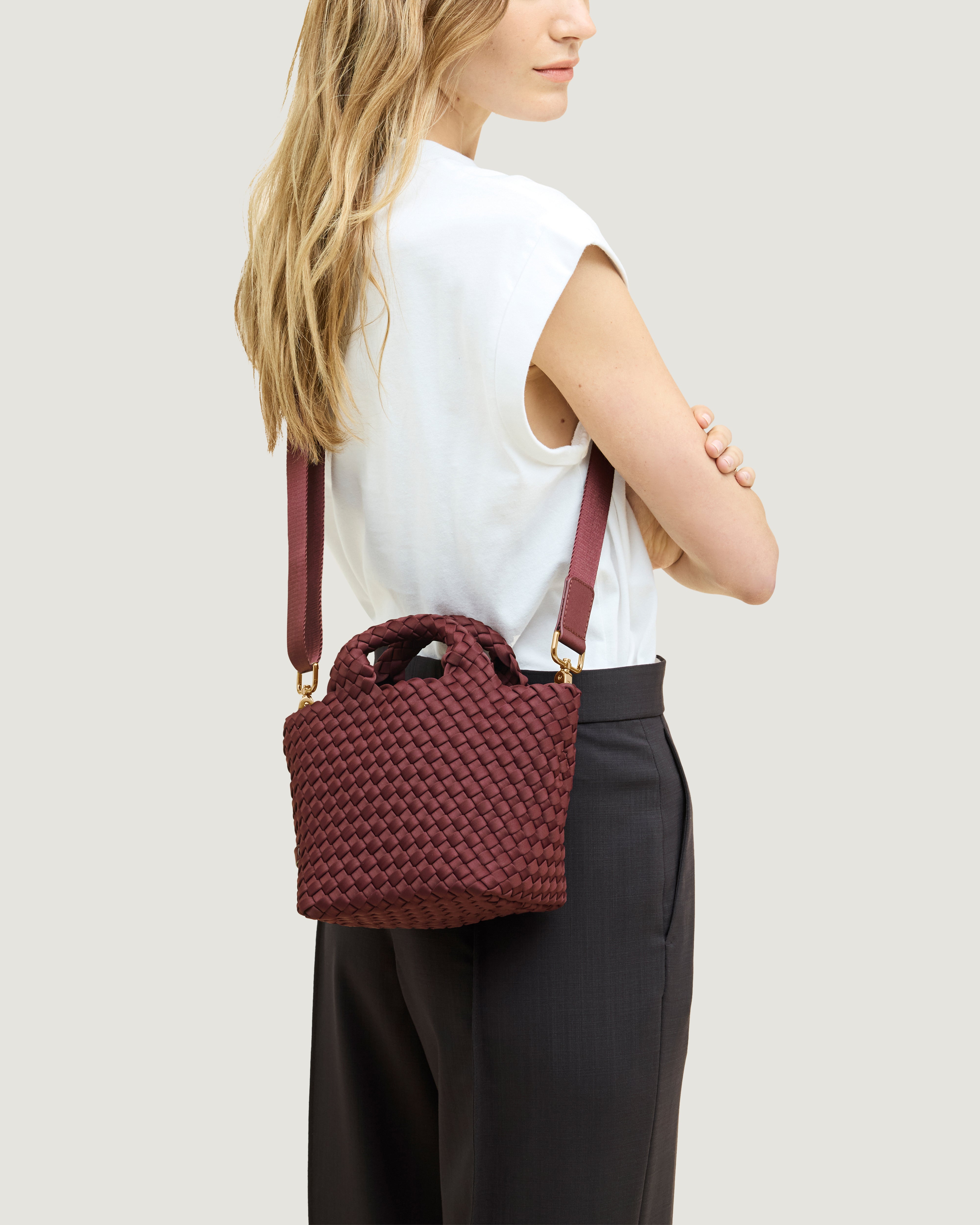 St. Barths Tote in Bordeaux shown on model to illustrate scale, adjustable shoulder strap, and soft silhouette.