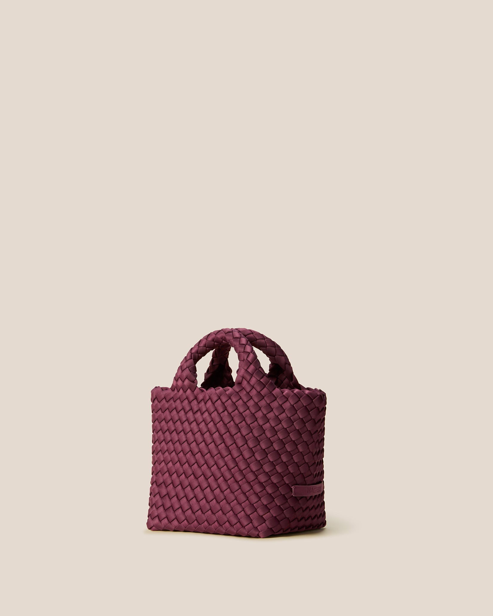 St. Barths Petit Tote Bag in Bordeaux shown from a side angle, highlighting its handwoven neoprene and open top.