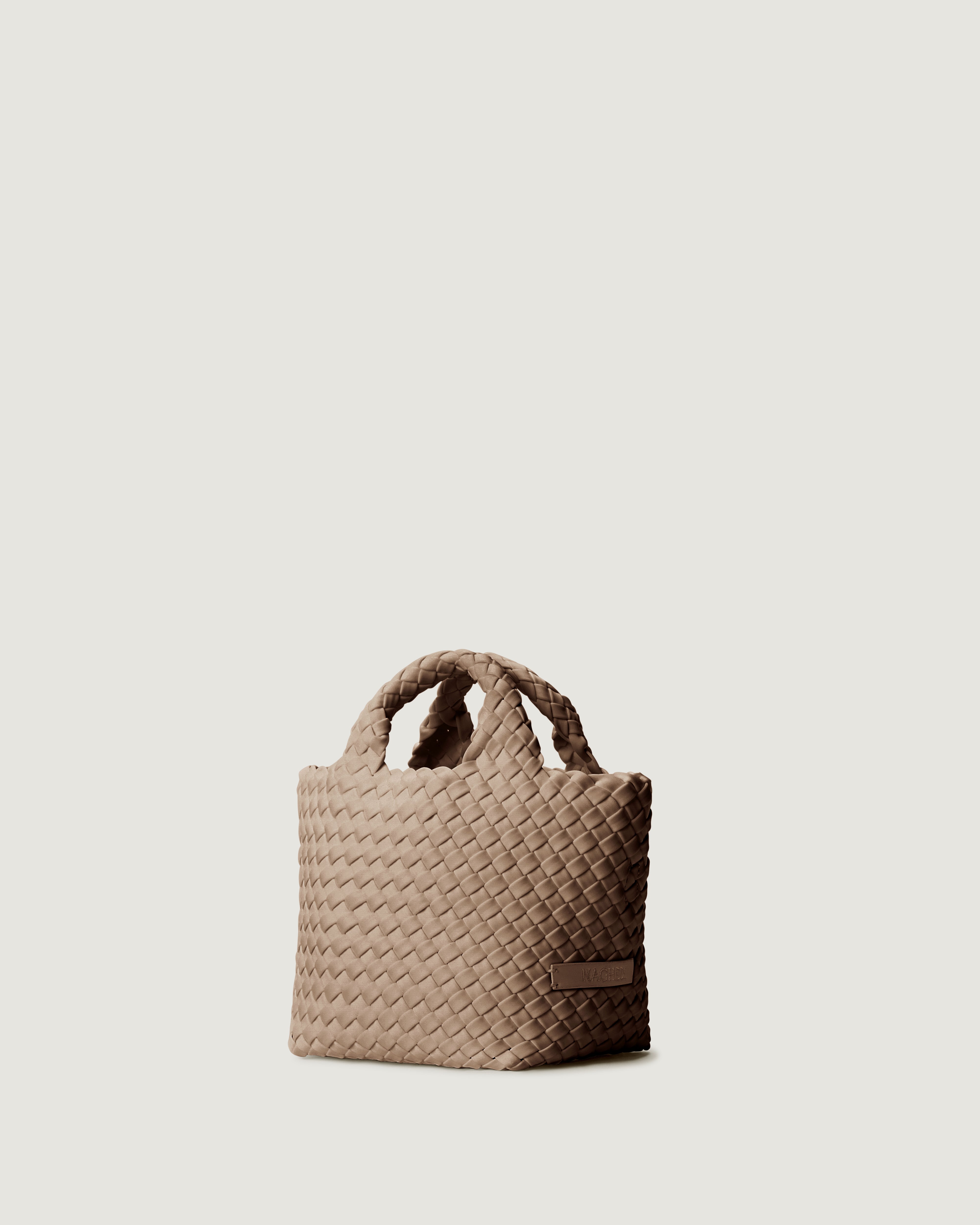 St. Barths Tote in Cashmere shown from a side angle, highlighting its handwoven neoprene construction and open top.