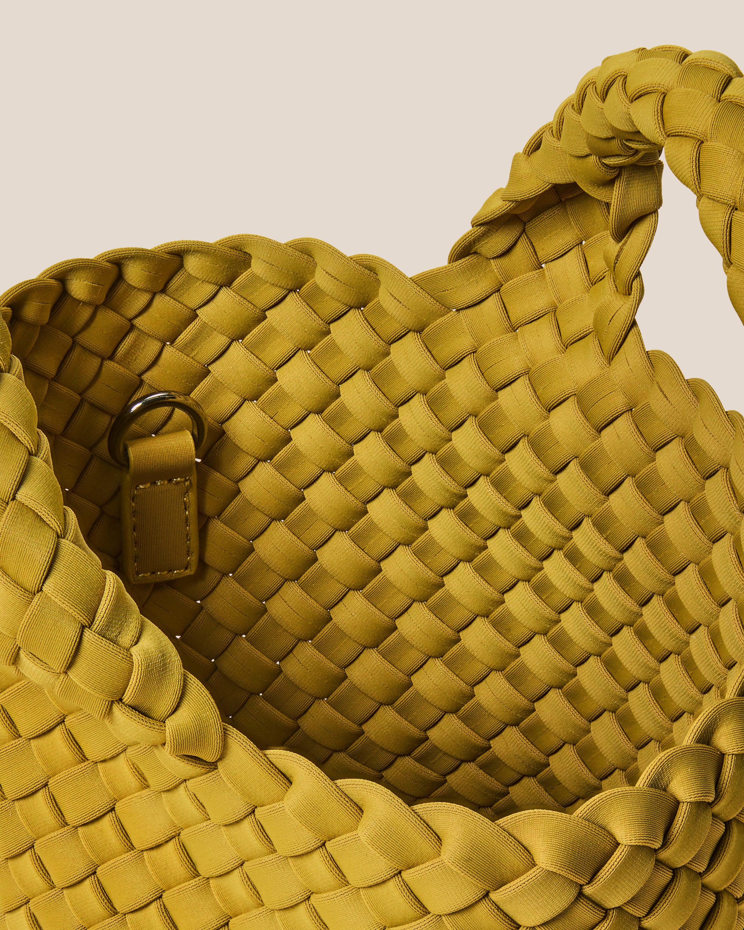 Interior close-up of St. Barths Tote in Chartreuse showing its open top, and unlined interior.