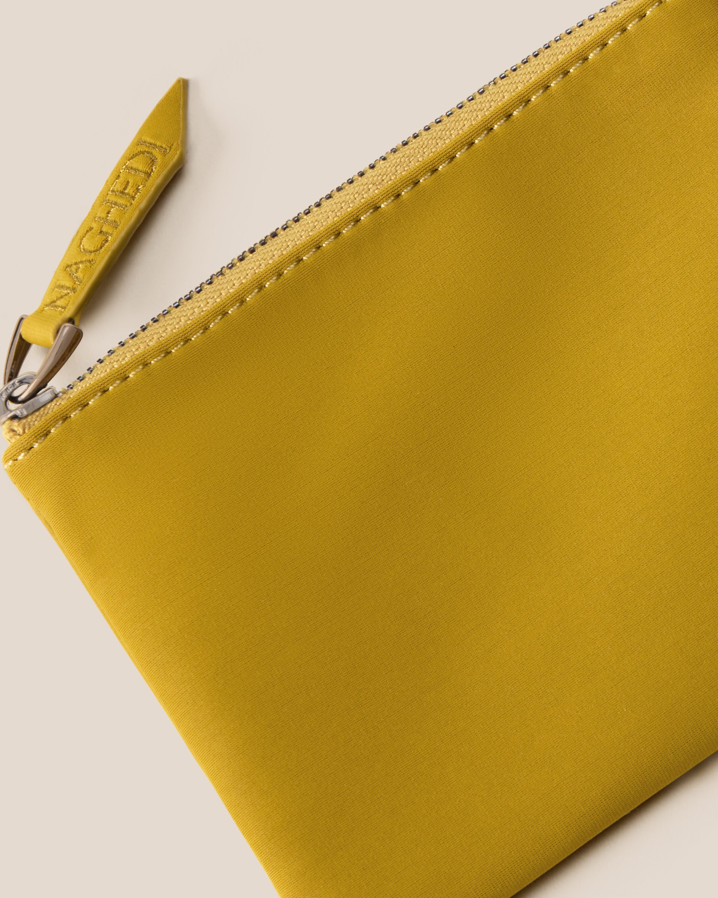 Close-up of included coordinating neoprene zippered pouch.