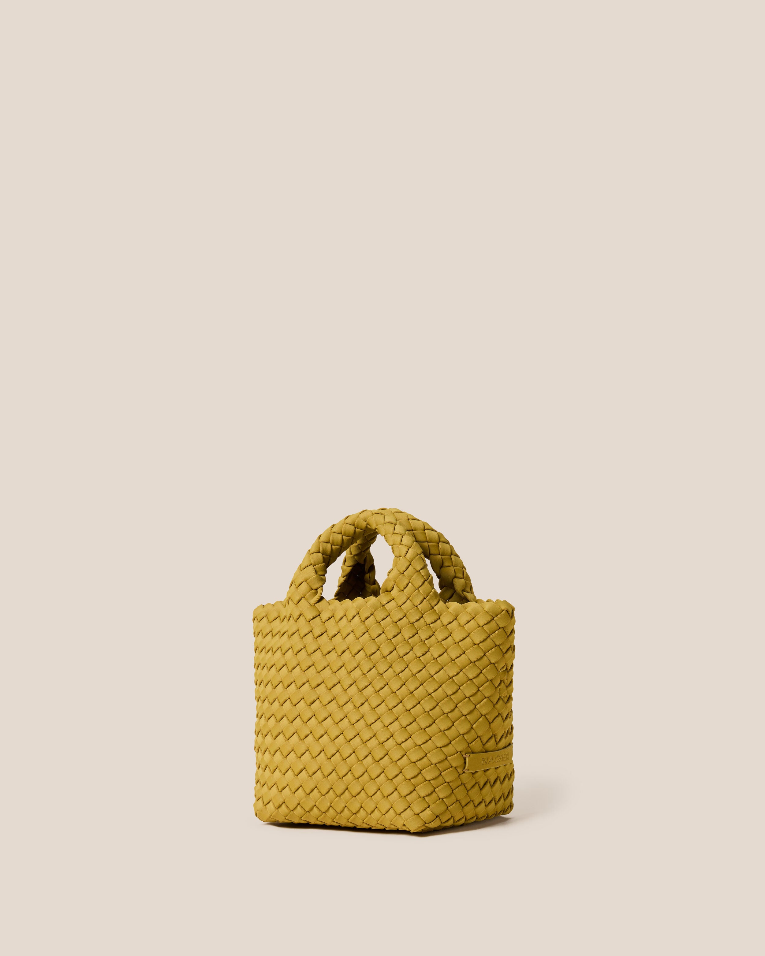 St. Barths Tote in Chartreuse shown from a side angle, highlighting its handwoven neoprene construction and open top.