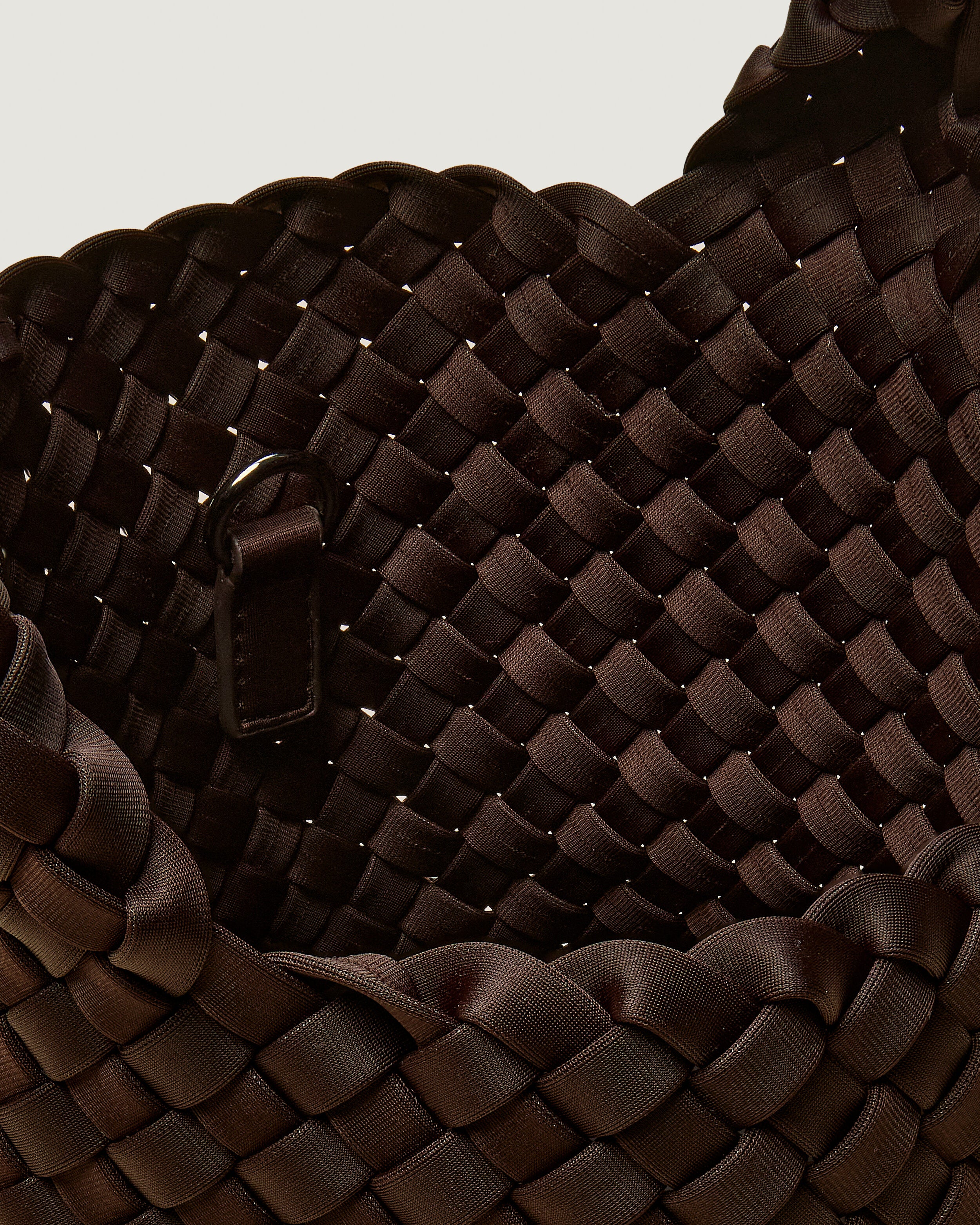 Interior close-up of St. Barths Tote in Chocolate showing its open top, and unlined interior.