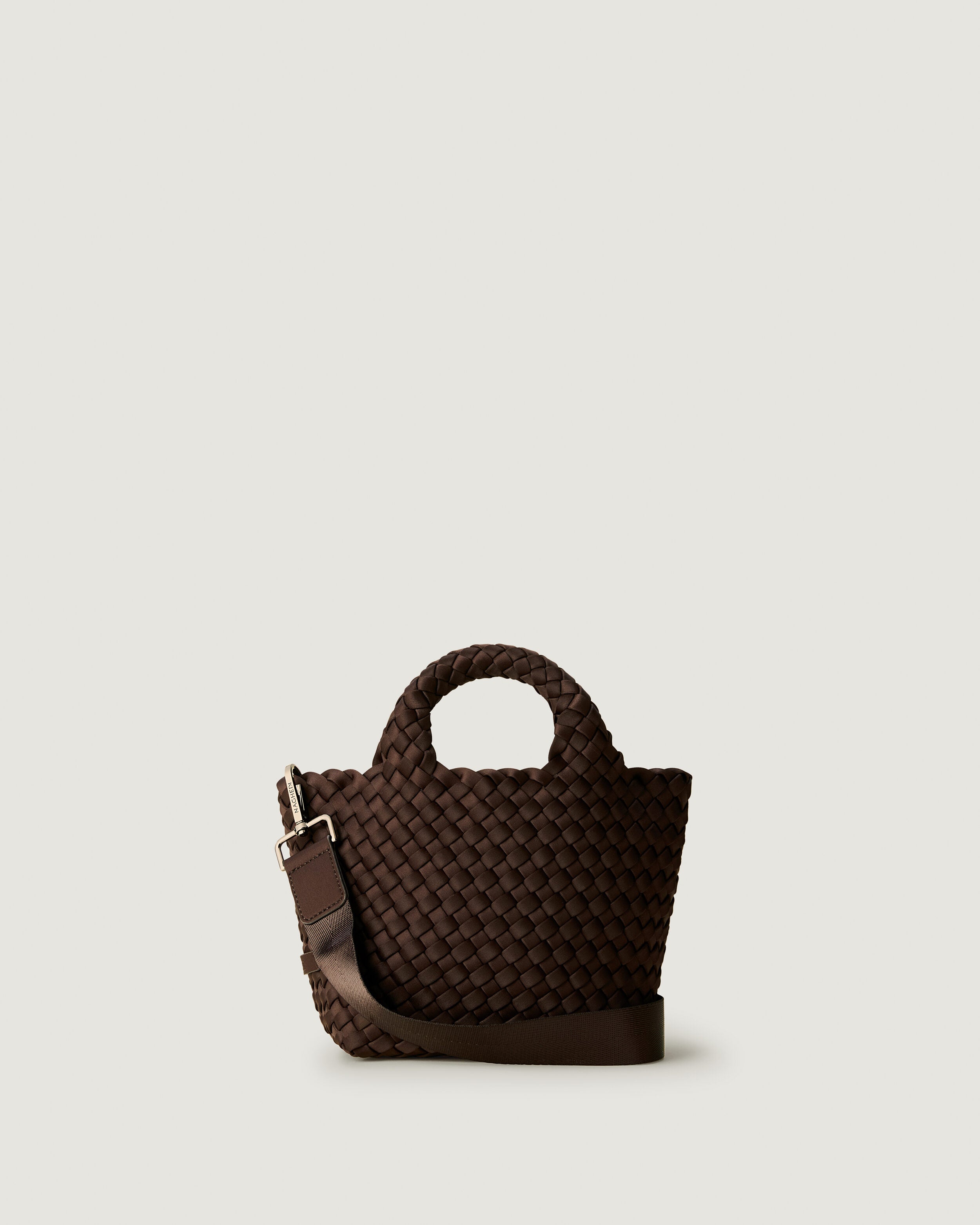 St. Barths Tote in Chocolate, a dark chocolate brown tone, in handwoven neoprene, featuring an open top, woven top handles, and detachable, adjustable nylon crossbody strap.