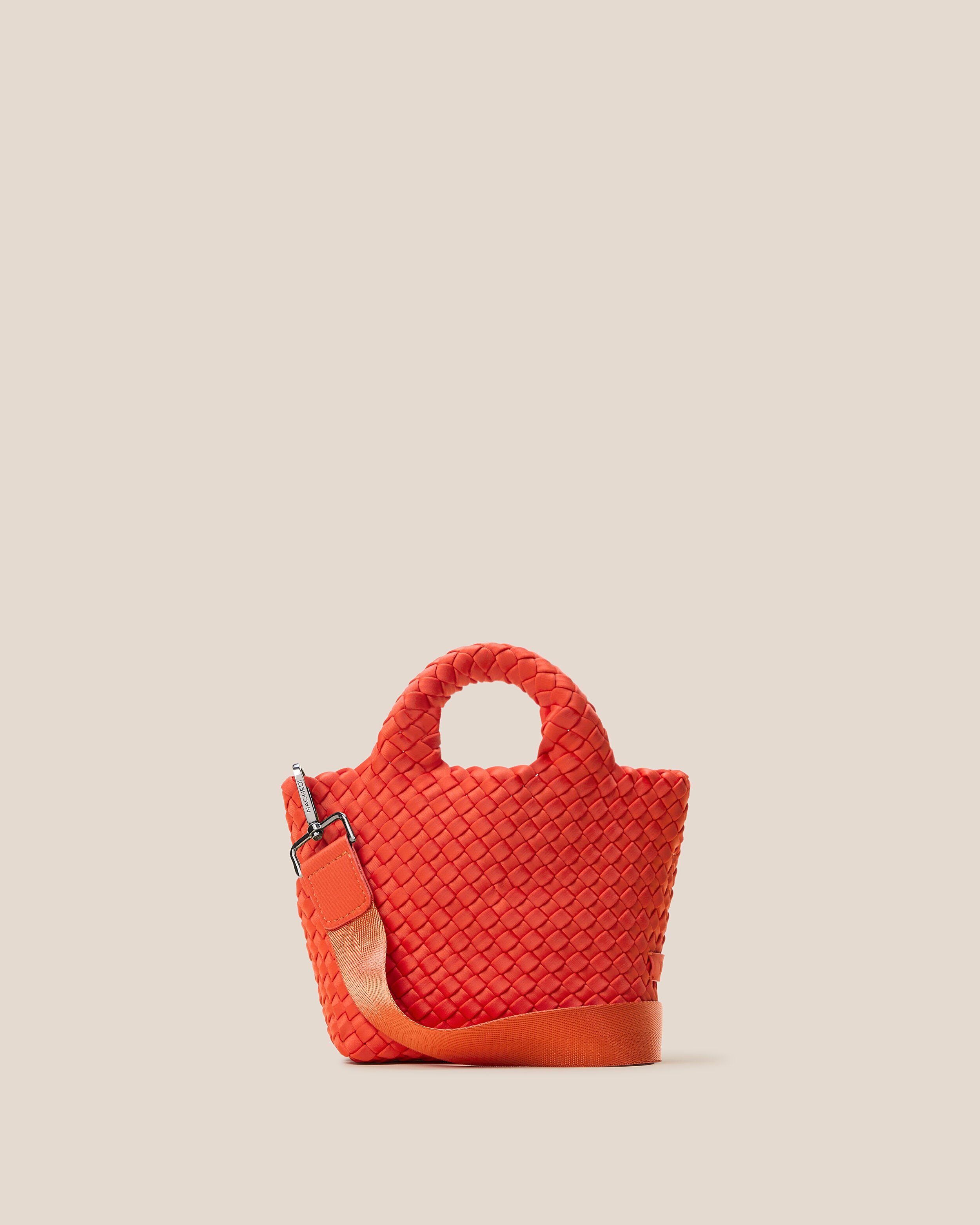 St. Barths Tote in Ipanema, a vibrant orange tone, in handwoven neoprene, featuring an open top, woven top handles, and detachable, adjustable nylon crossbody strap.