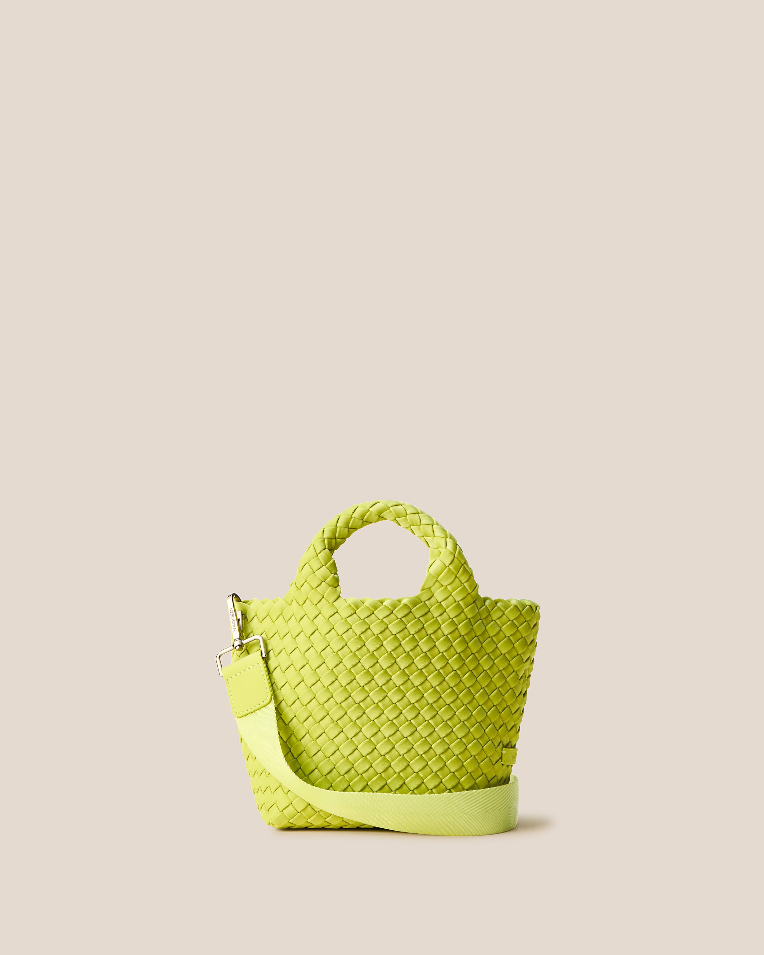 St. Barths Tote in Matcha, a lime green tone, in handwoven neoprene, featuring an open top, woven top handles, and detachable, adjustable nylon crossbody strap.