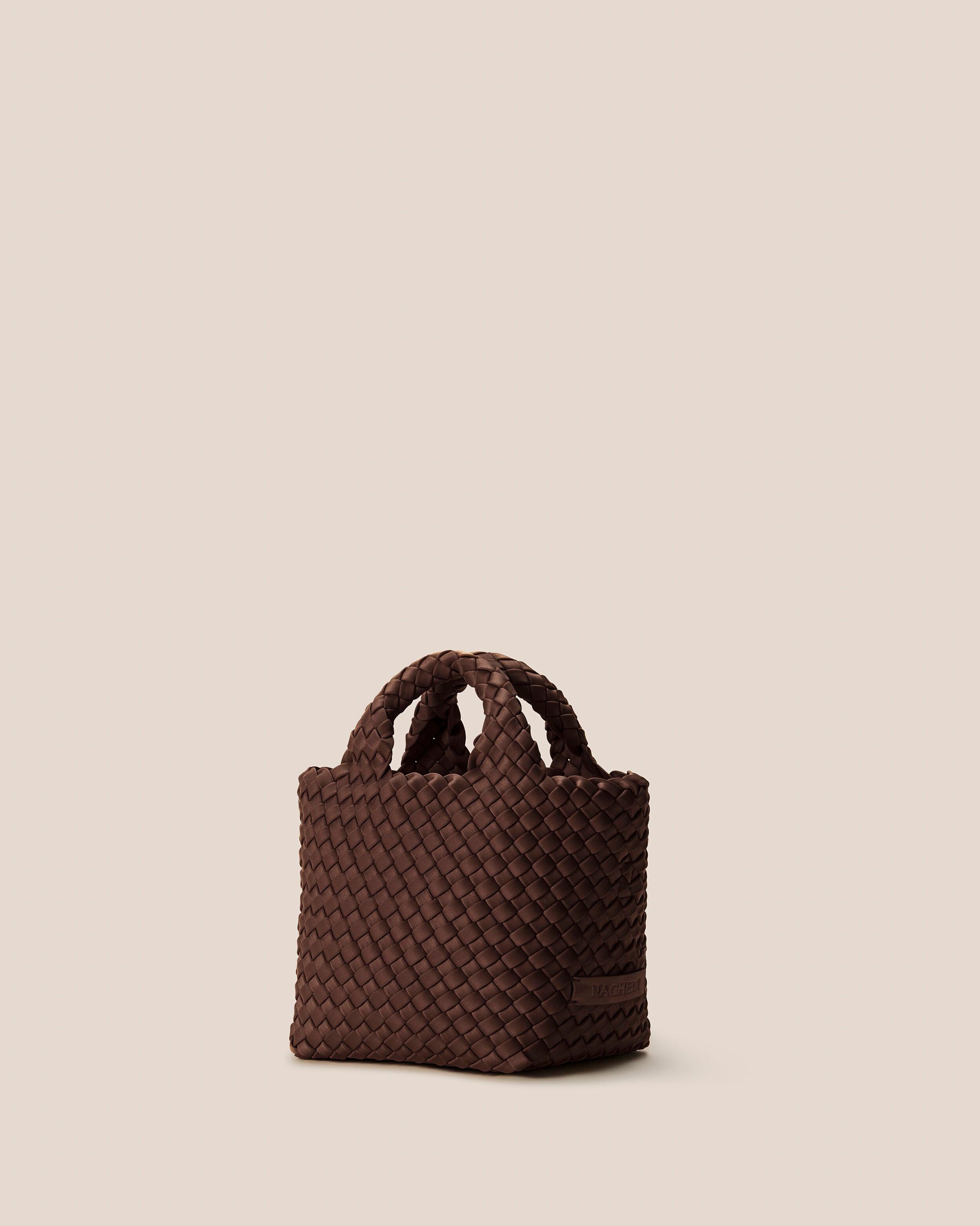 St. Barths Tote in Mocha shown from a side angle, highlighting its handwoven neoprene construction and open top.