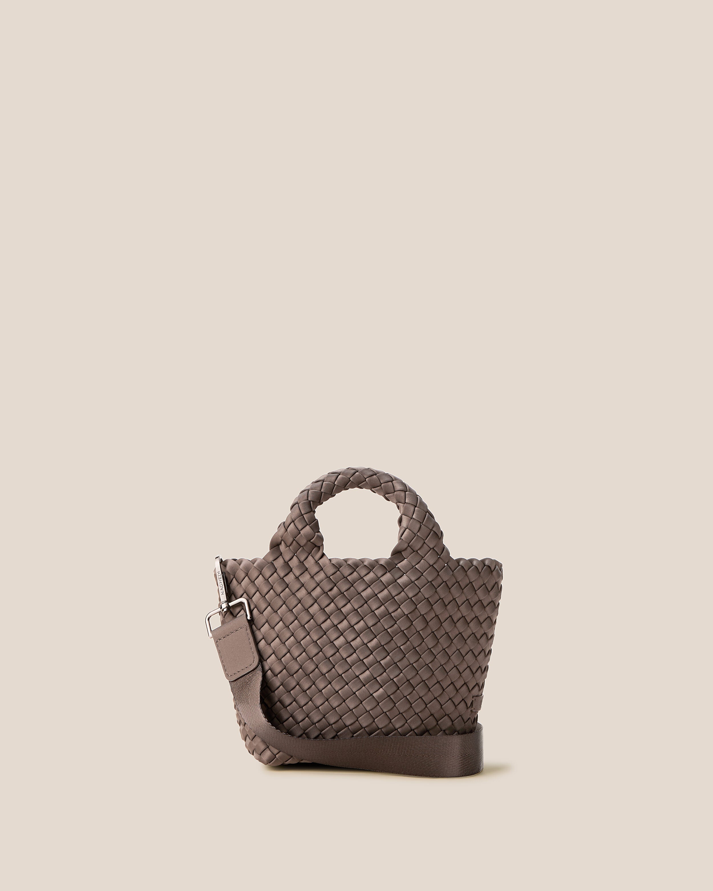 St. Barths Tote in Napa, a dark brown tone, in handwoven neoprene, featuring an open top, woven top handles, and detachable, adjustable nylon crossbody strap.