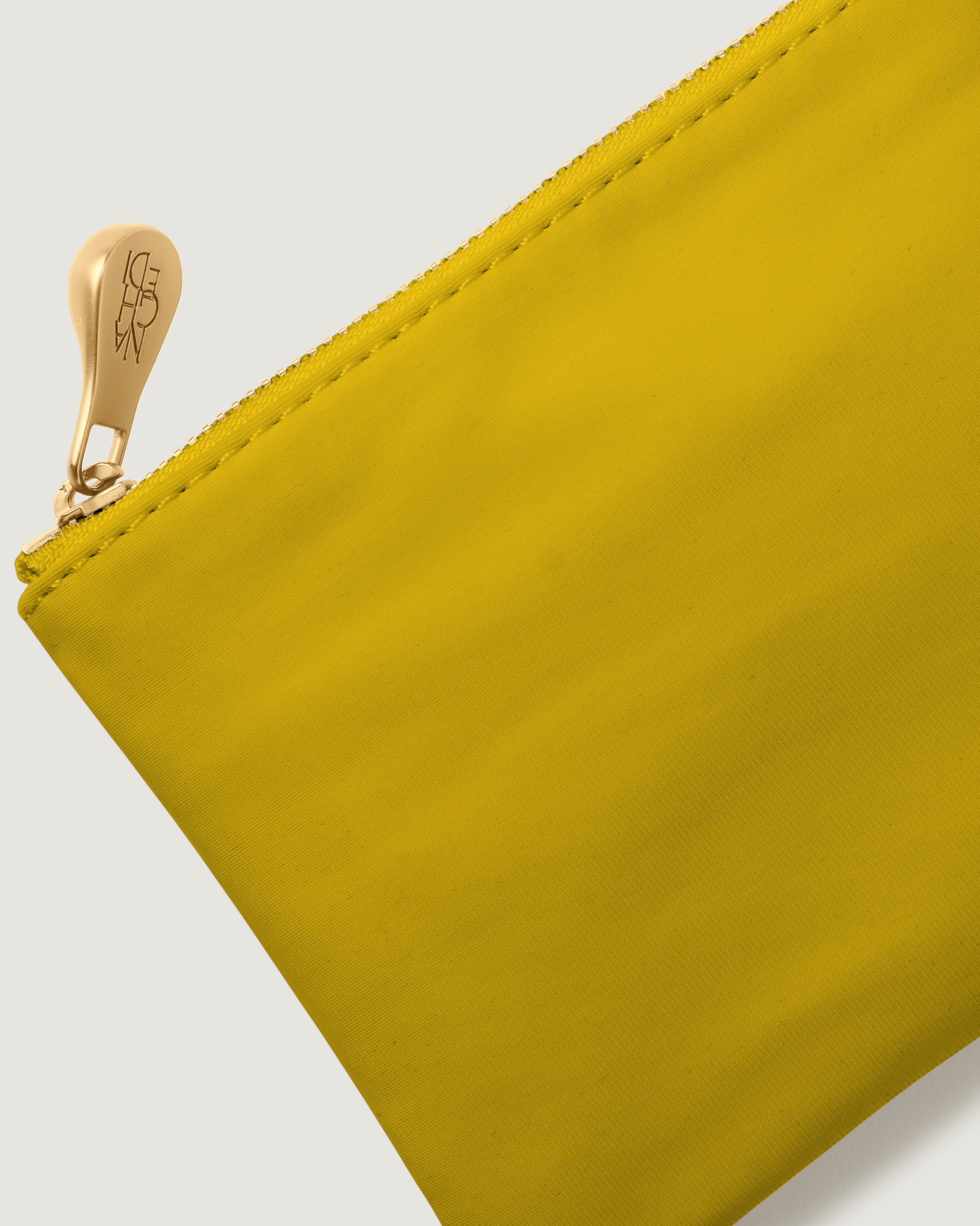 Close up of golden chartreuse neoprene pouch included with bag purchase