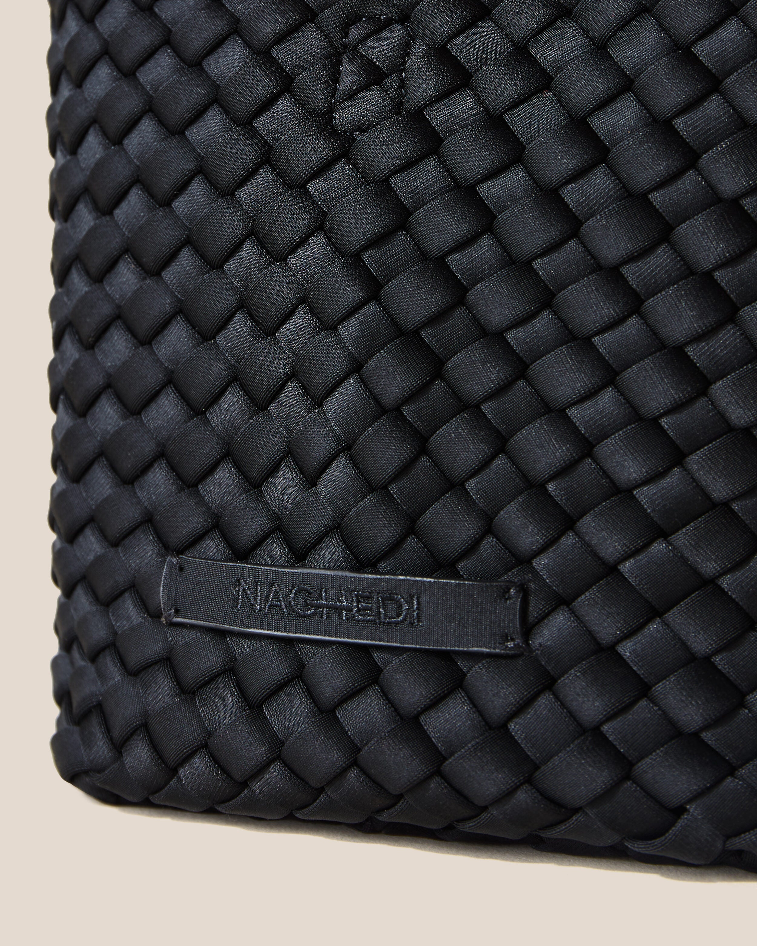 Close-up of stamped NAGHEDI logo on St. Barths Tote in Onyx.
