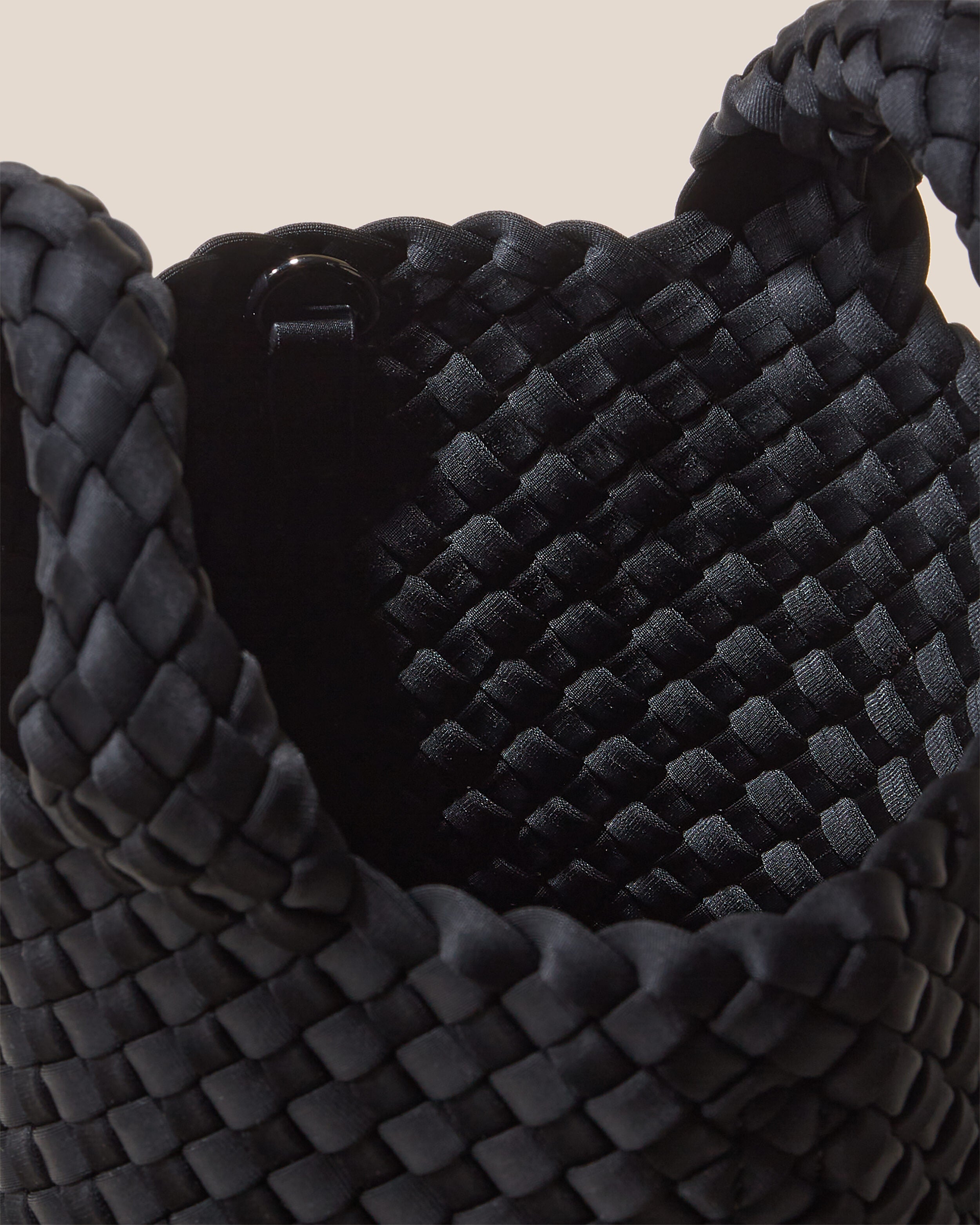 Interior close-up of St. Barths Tote in Onyx showing its open top, and unlined interior.