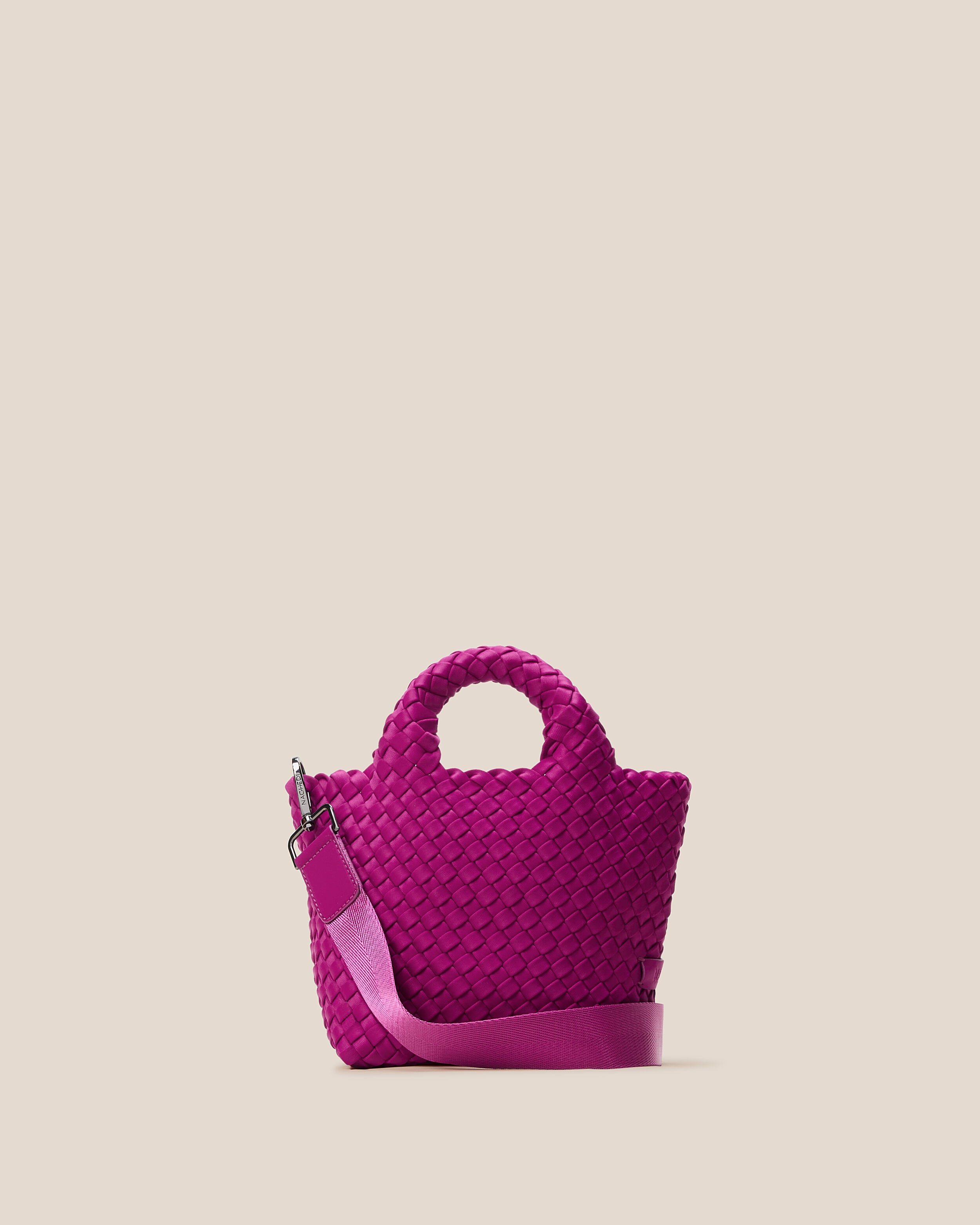 St. Barths Tote in Rio, a fuchsia tone, in handwoven neoprene, featuring an open top, woven top handles, and detachable, adjustable nylon crossbody strap.