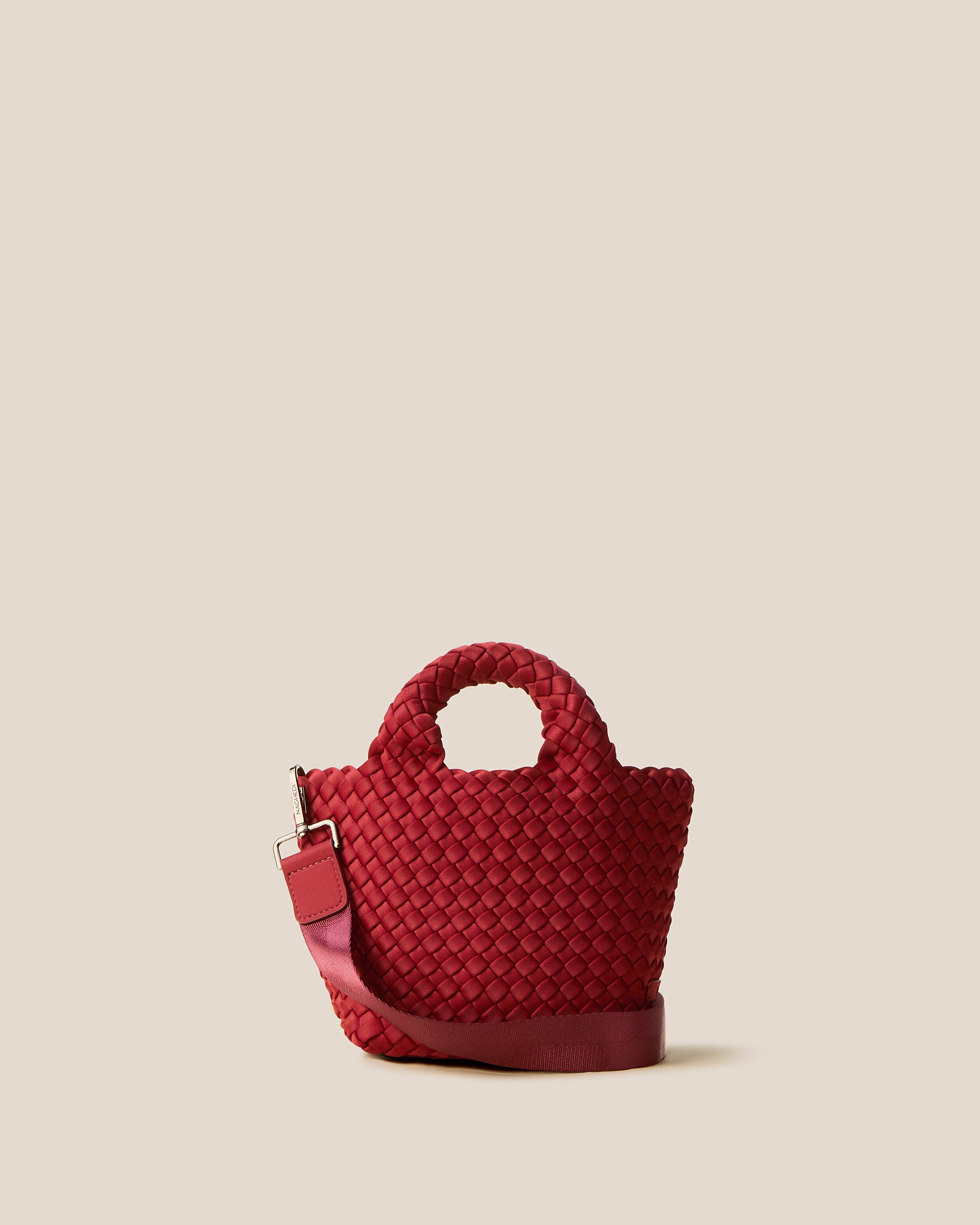 St. Barths Tote in Rosso, a rich red tone, in handwoven neoprene, featuring an open top, woven top handles, and detachable, adjustable nylon crossbody strap.