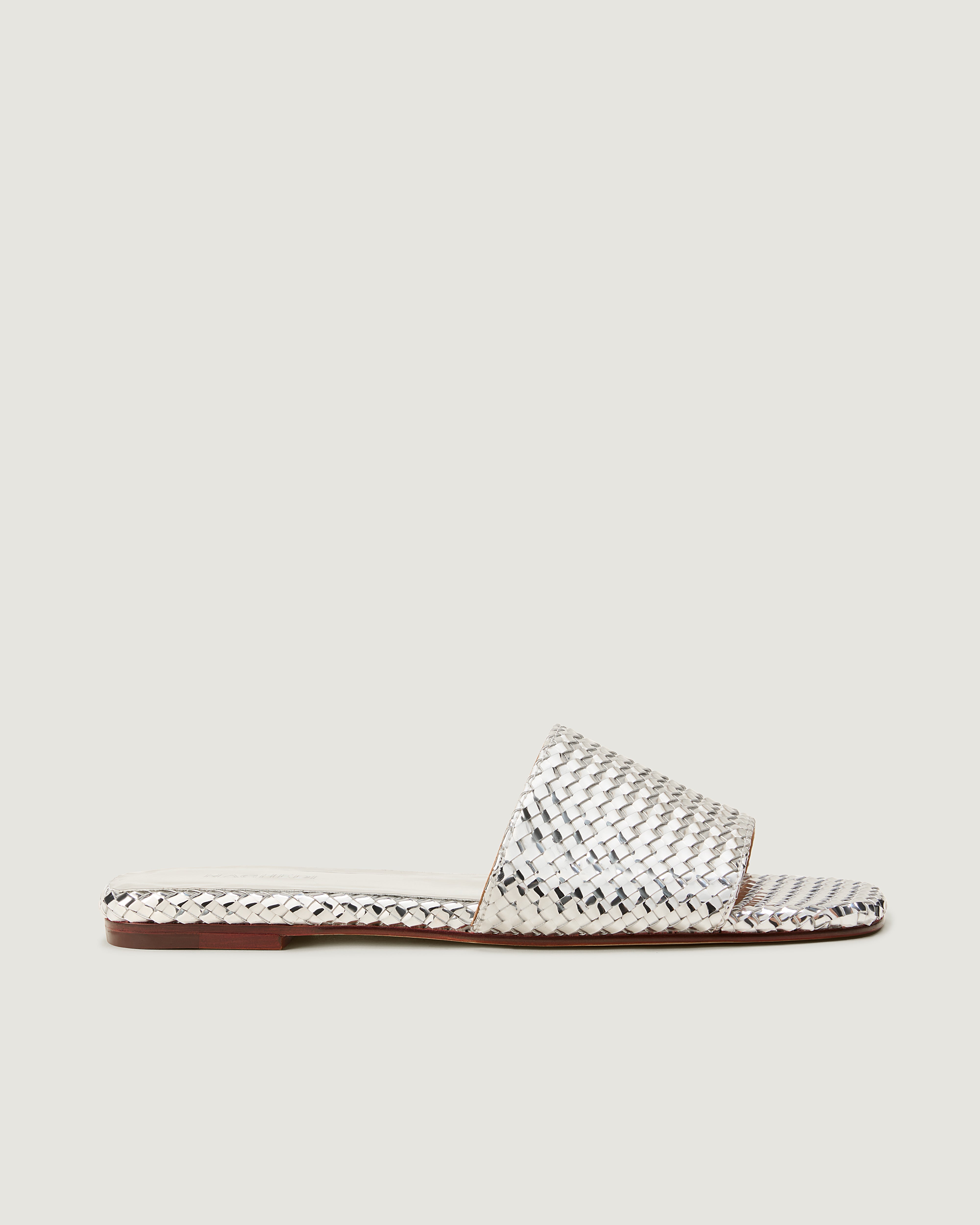 Side view of The St. Barths Slide in Silver,  featuring an open toe and square silhouette.