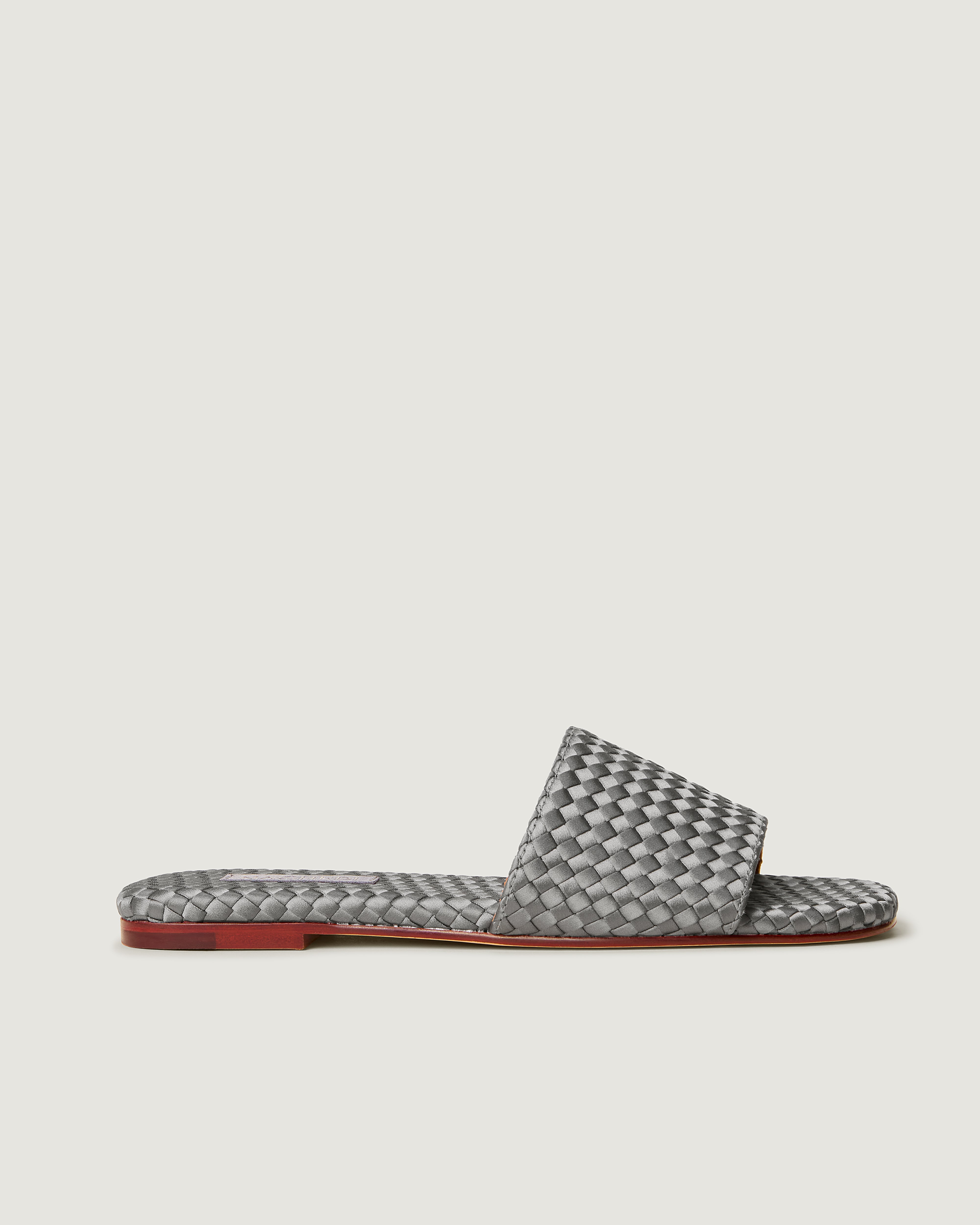 Side view of The St. Barths Slide in Graphite, a blue-grey tone, featuring an open toe and square silhouette.