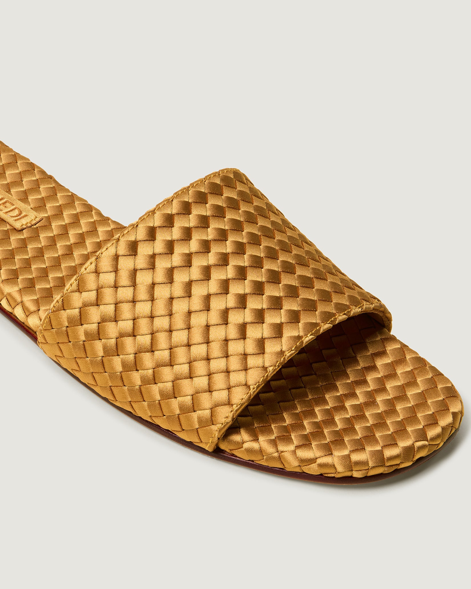 Close-up of St. Barths Satin Slide Sandals in Ore showing its open toe and square silhouette.