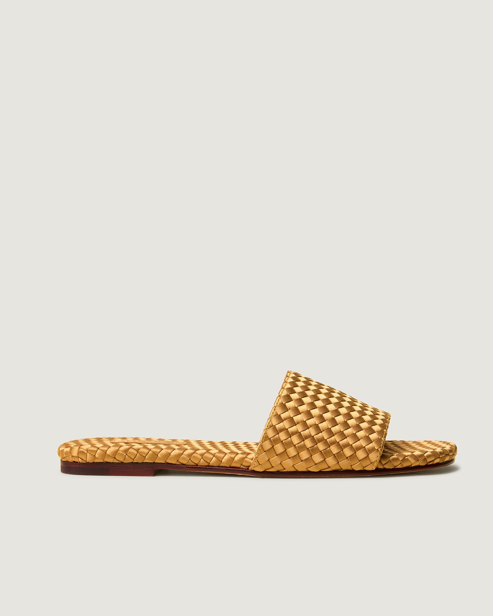 Side view of St. Barths Satin Slide Sandals in Ore, a golden yellow tone, featuring an open toe and square silhouette.