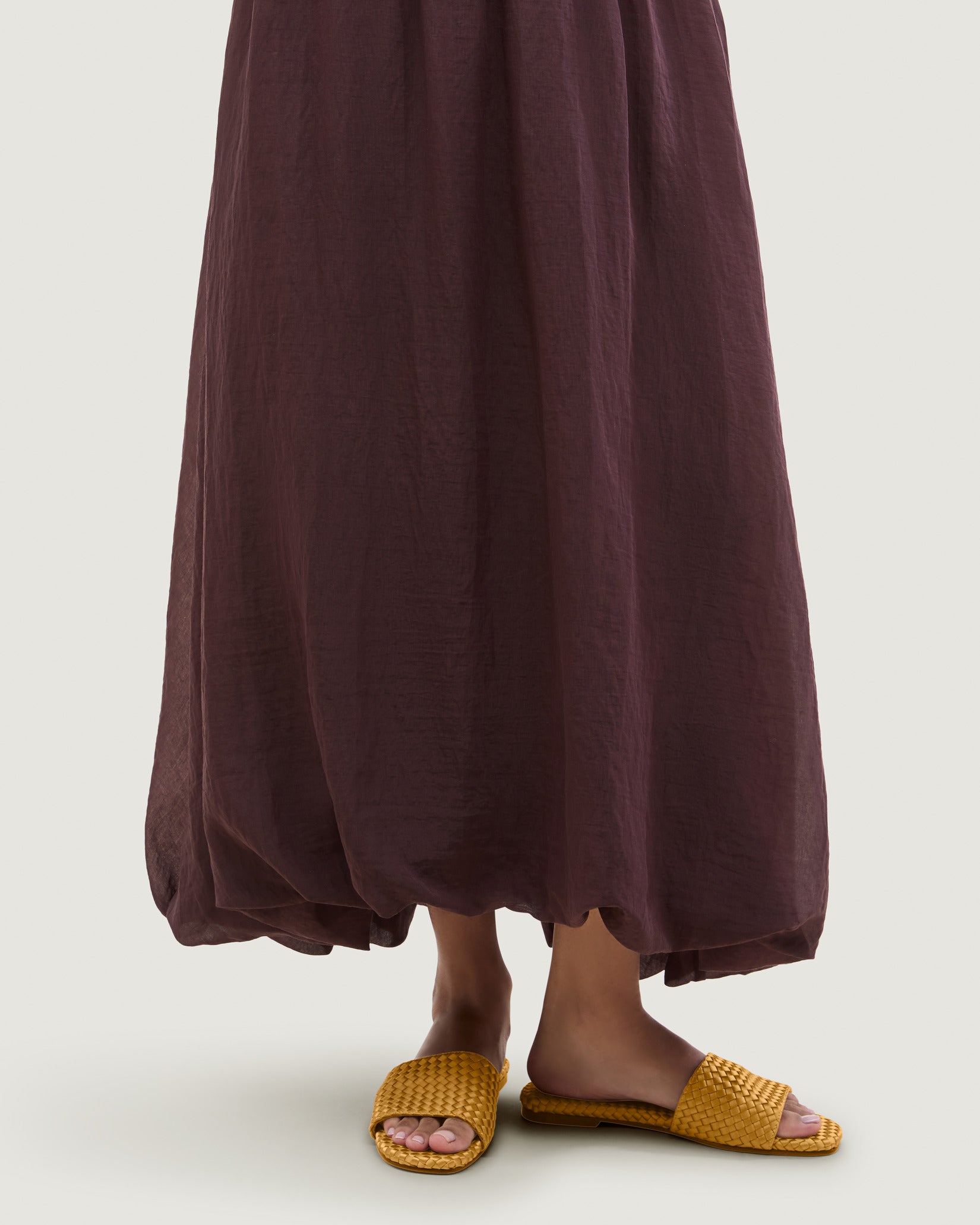 St. Barths Satin Slide Sandals in Ore shown on model.