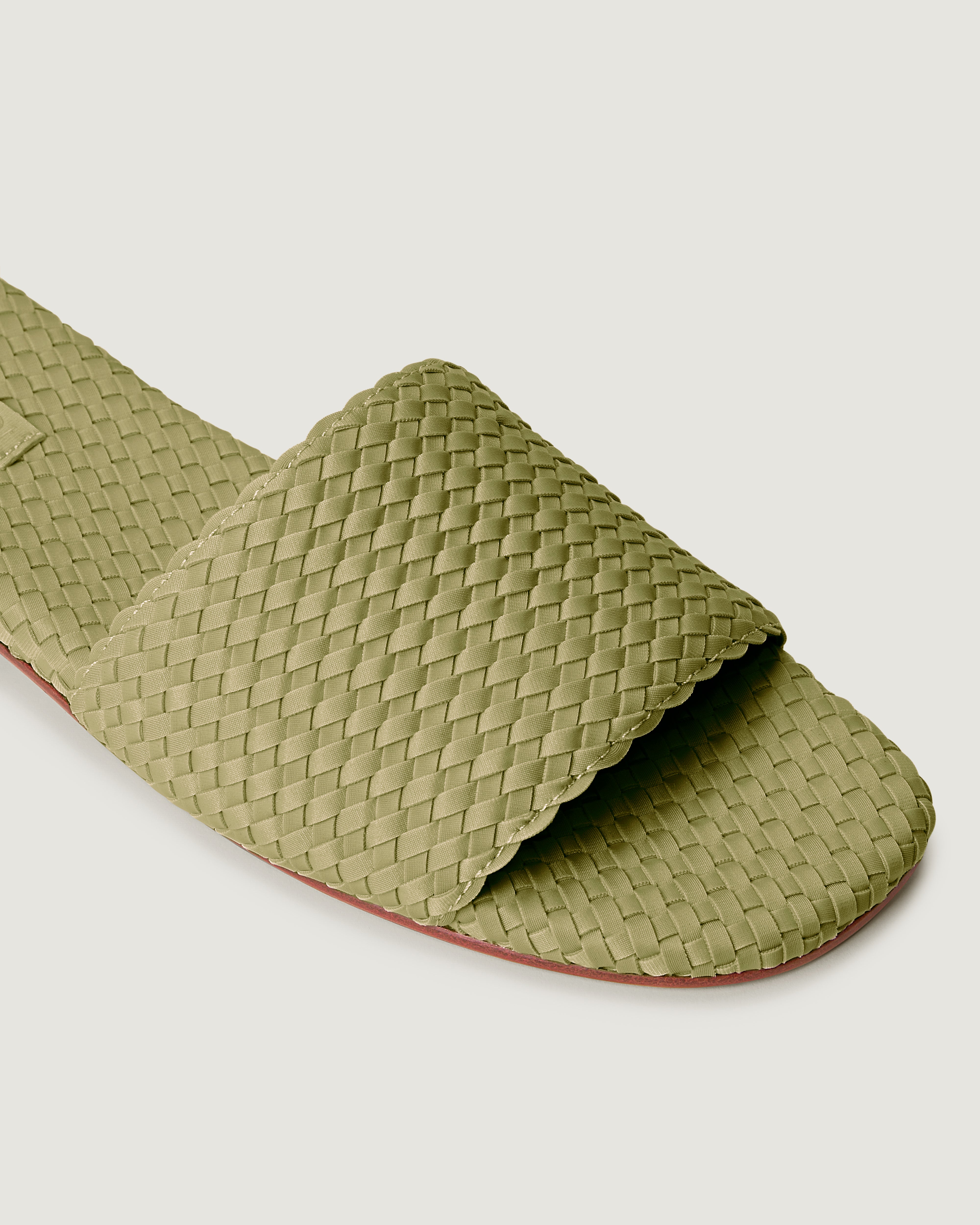 Close-up of The St. Barths Slide in Bottle Green showing its open toe and square silhouette.