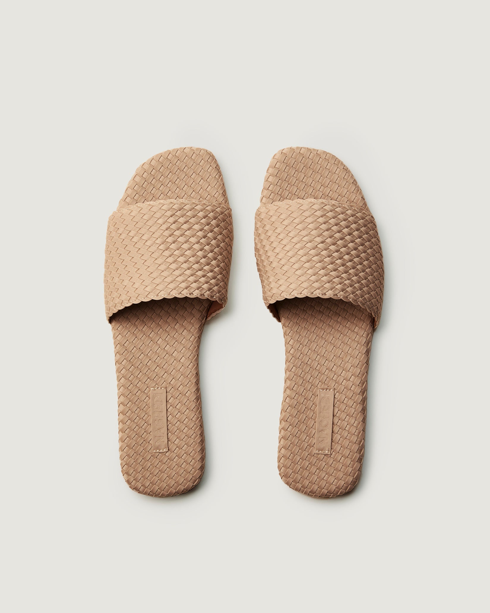 Top view of pair of St. Barths Slide Sandals in Camel showing the handwoven neoprene insole.