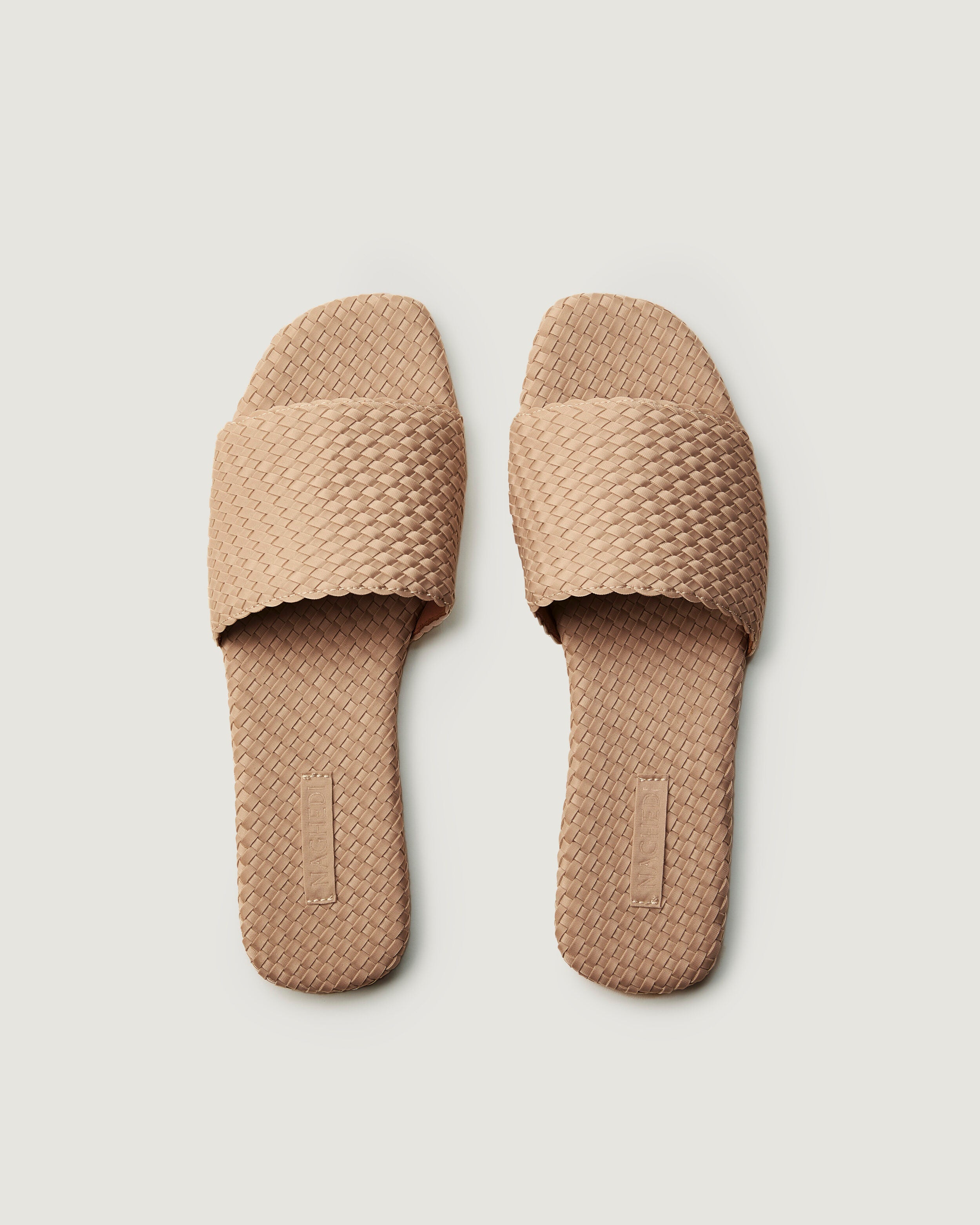 Top view of pair of The St. Barths Slide in Camel showing the handwoven neoprene insole.