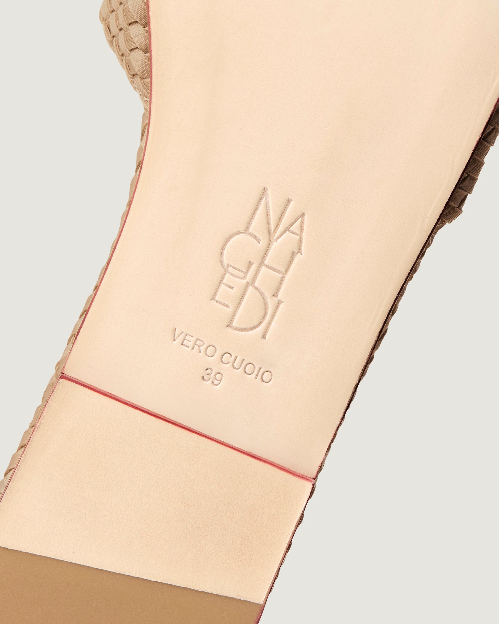 Shoe sole showing natural buffed leather sole, stamped NAGHEDI logo and size detail for St. Barths Slide Sandals in Camel.