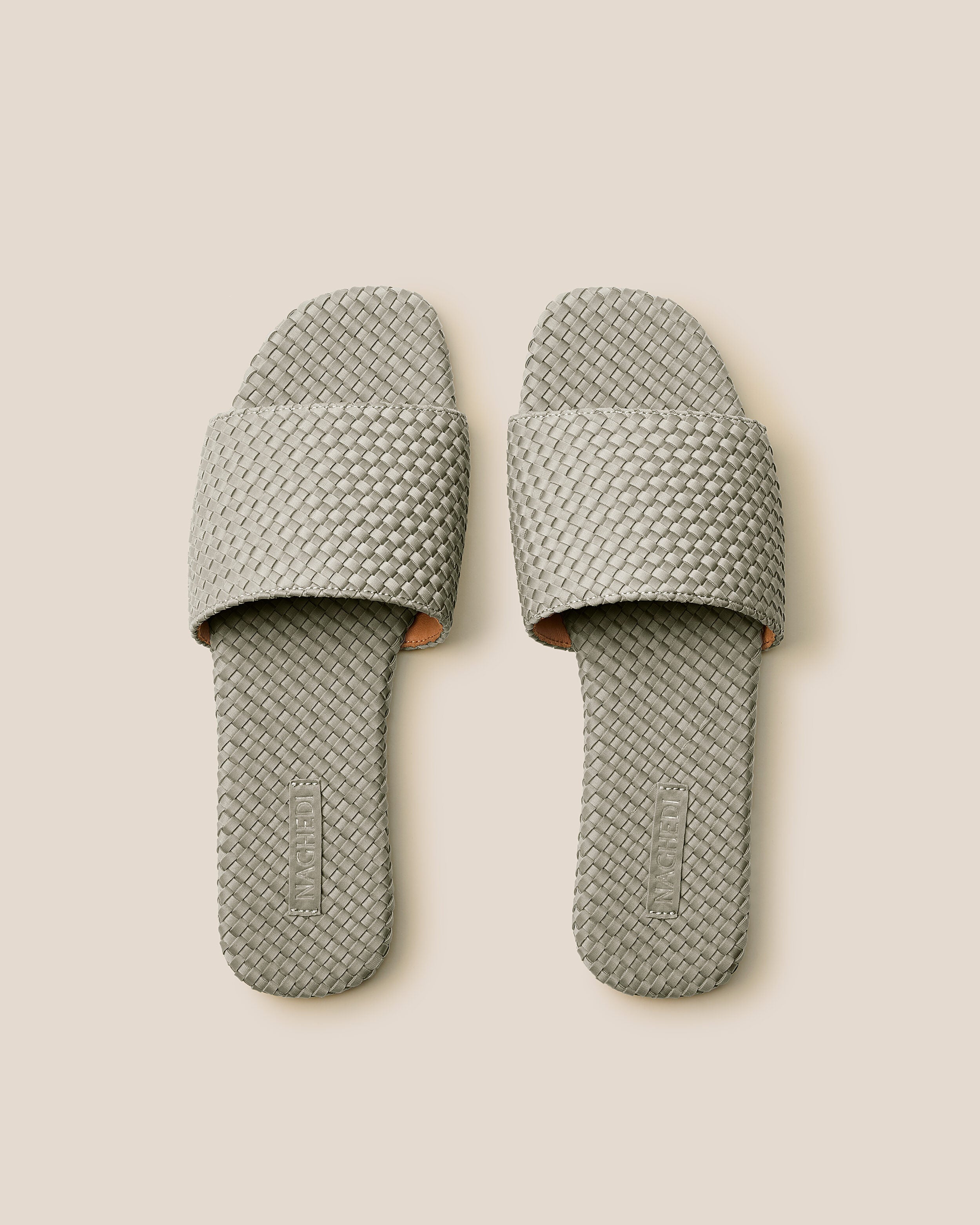 Top view of pair of The St. Barths Slide in Celadon showing the handwoven neoprene insole.