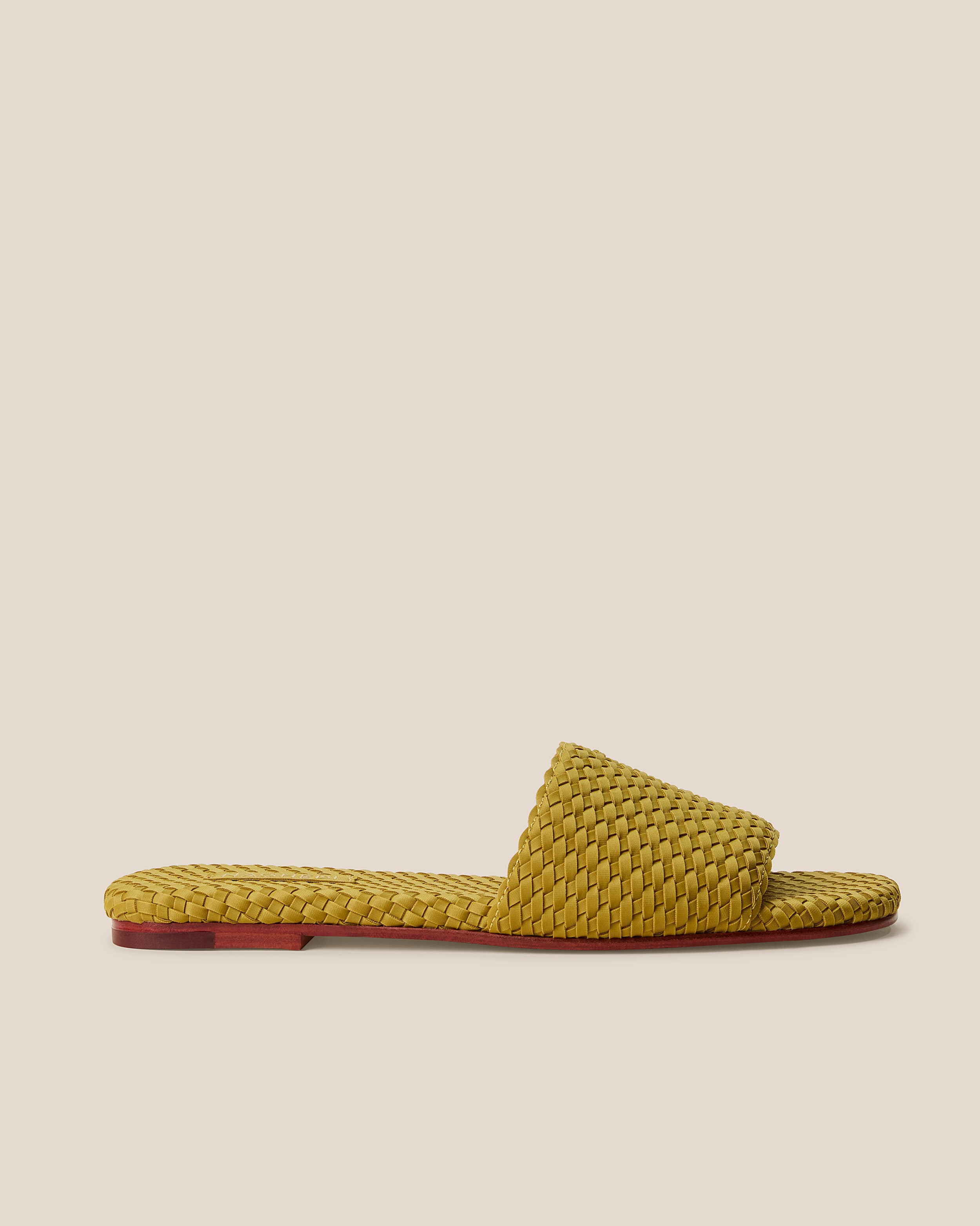 Side view of The St. Barths Slide in Chartreuse, a yellow-green tone, featuring an open toe and square silhouette.