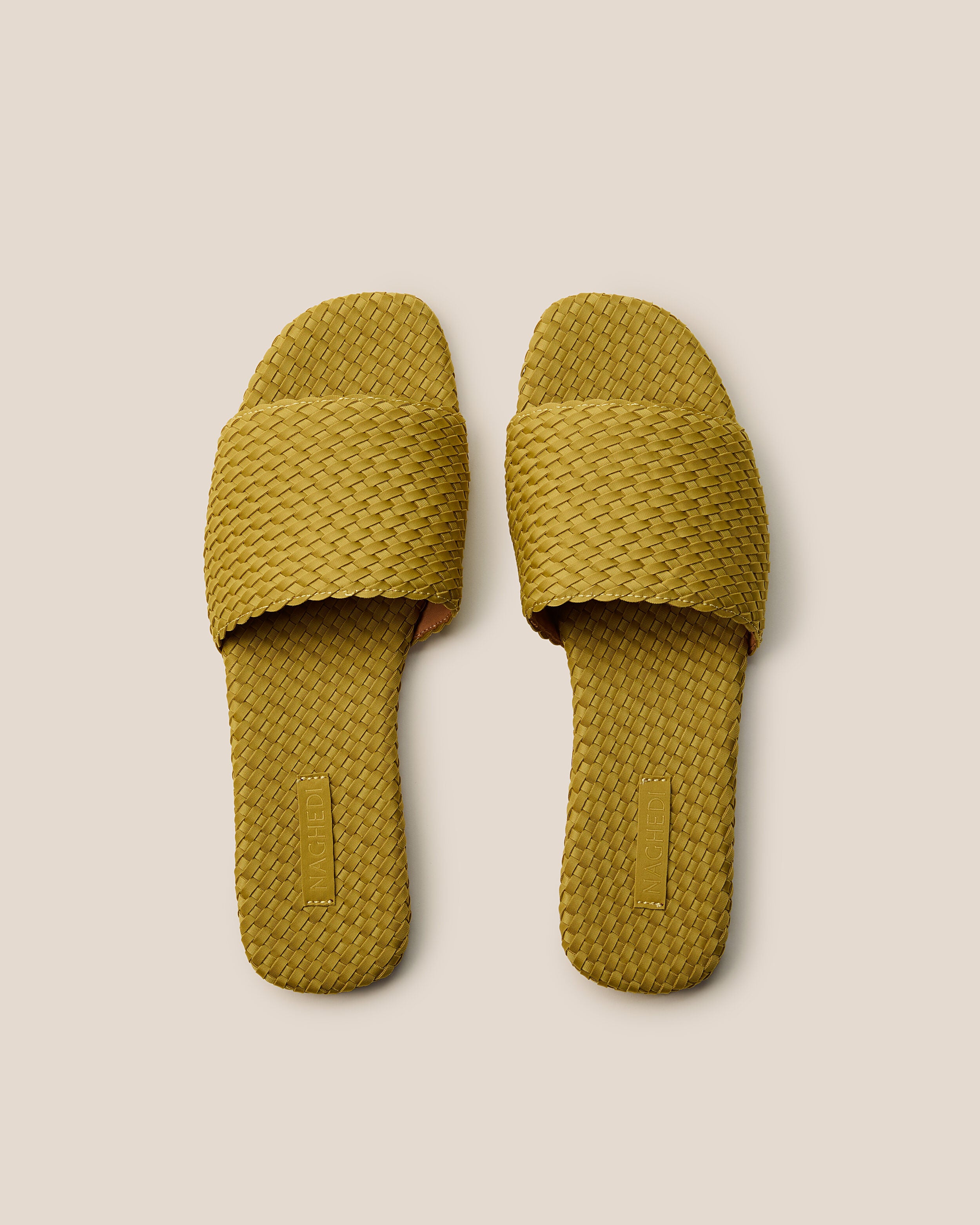 Top view of pair of The St. Barths Slide in Chartreuse showing the handwoven neoprene insole.
