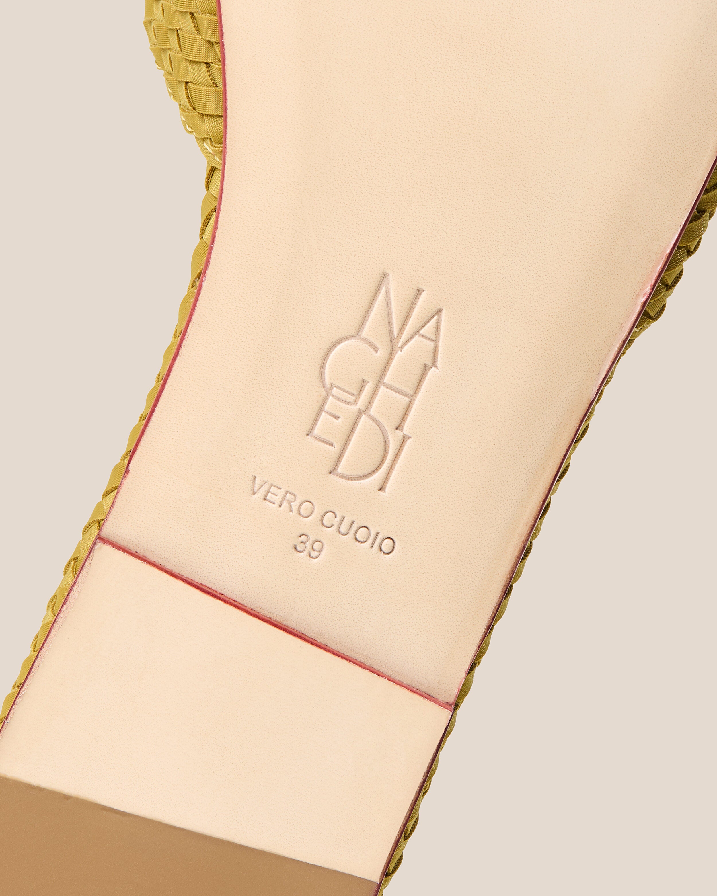 Shoe sole showing natural buffed leather sole, stamped NAGHEDI logo and size detail for The St. Barths Slide in Chartreuse.
