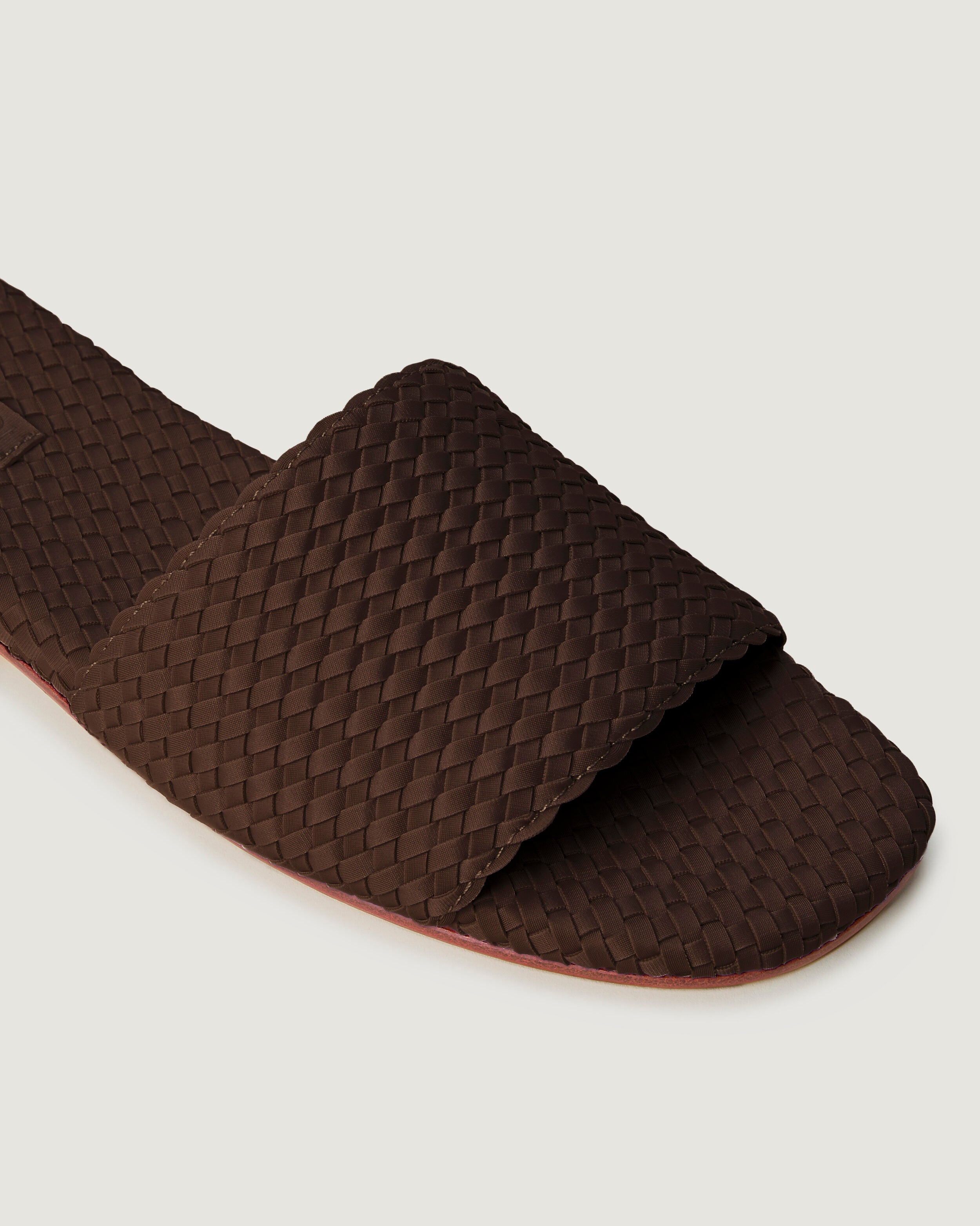 Close-up of The St. Barths Slide in Chocolate showing its open toe and square silhouette.