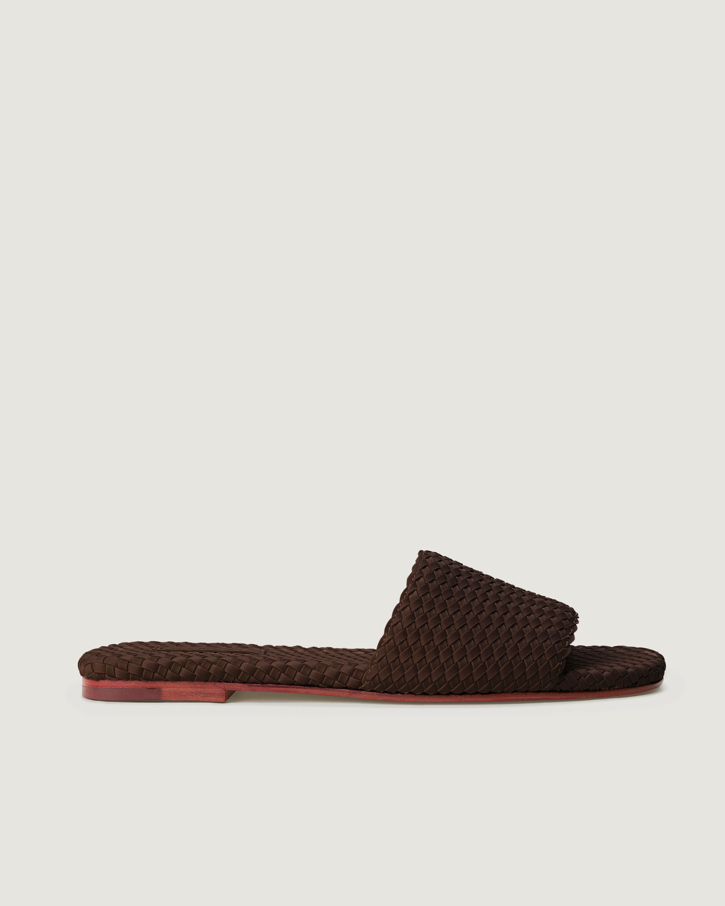 Side view of The St. Barths Slide in Chocolate, a dark chocolate brown tone, featuring an open toe and square silhouette.
